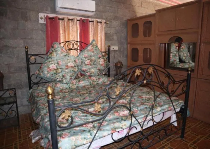 Bed in PRITHVI FARM COTTAGE AND VILLA