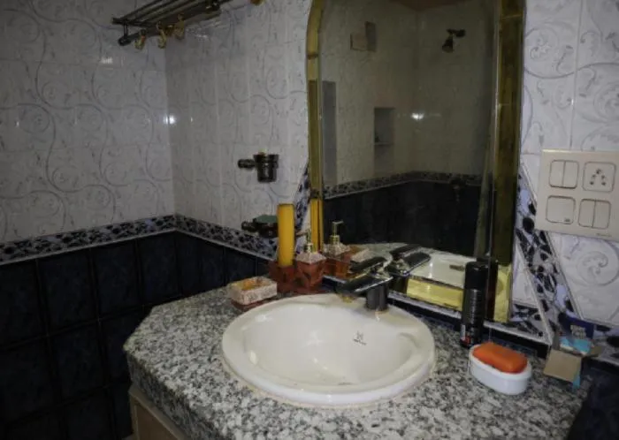 Shower in PRITHVI FARM COTTAGE AND VILLA