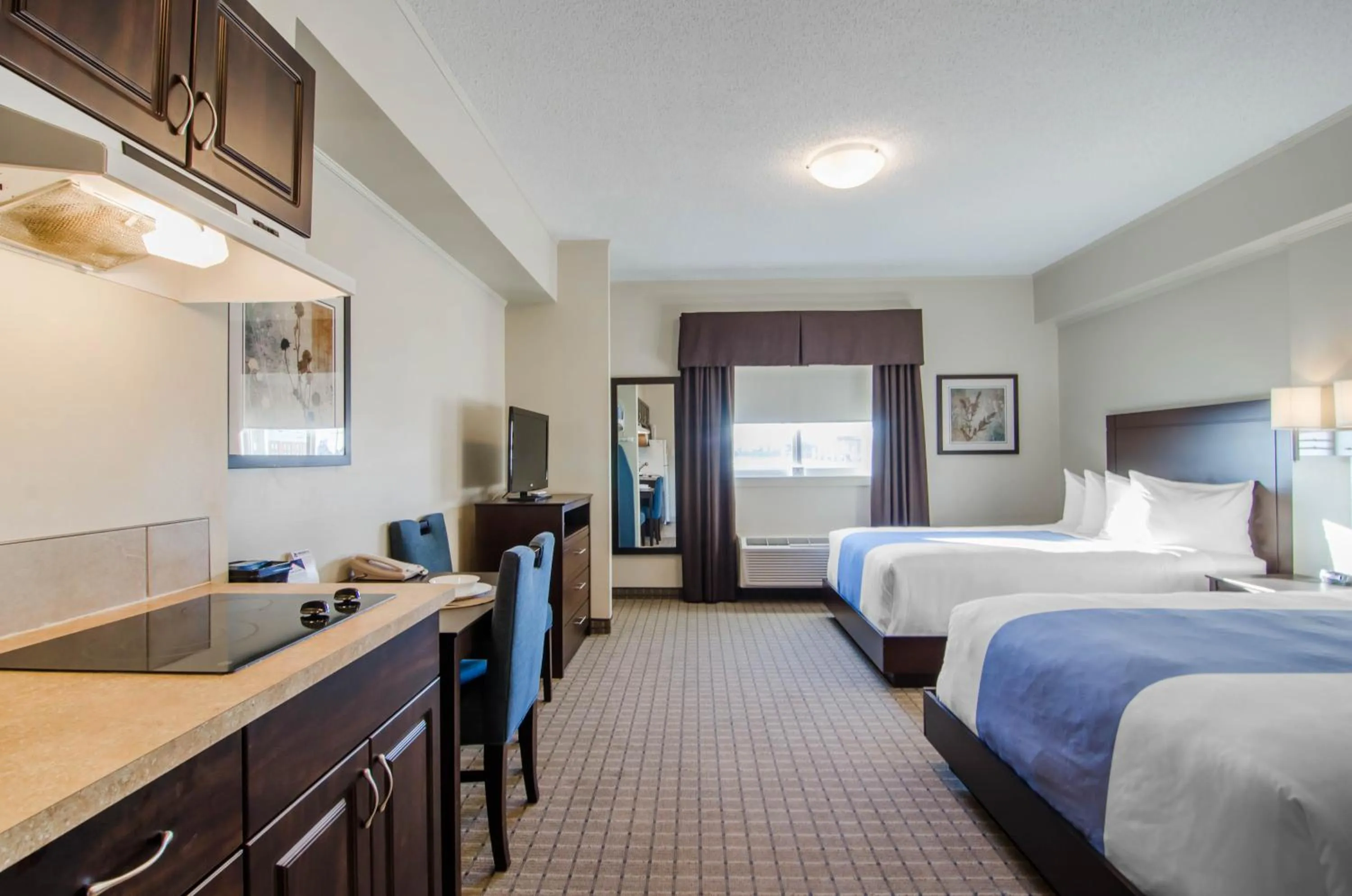 Bed in Kindersley All Suites Hotel