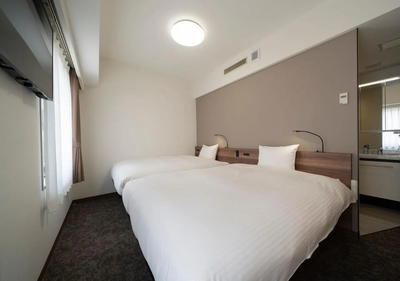 Bed in Nagoya B's Hotel