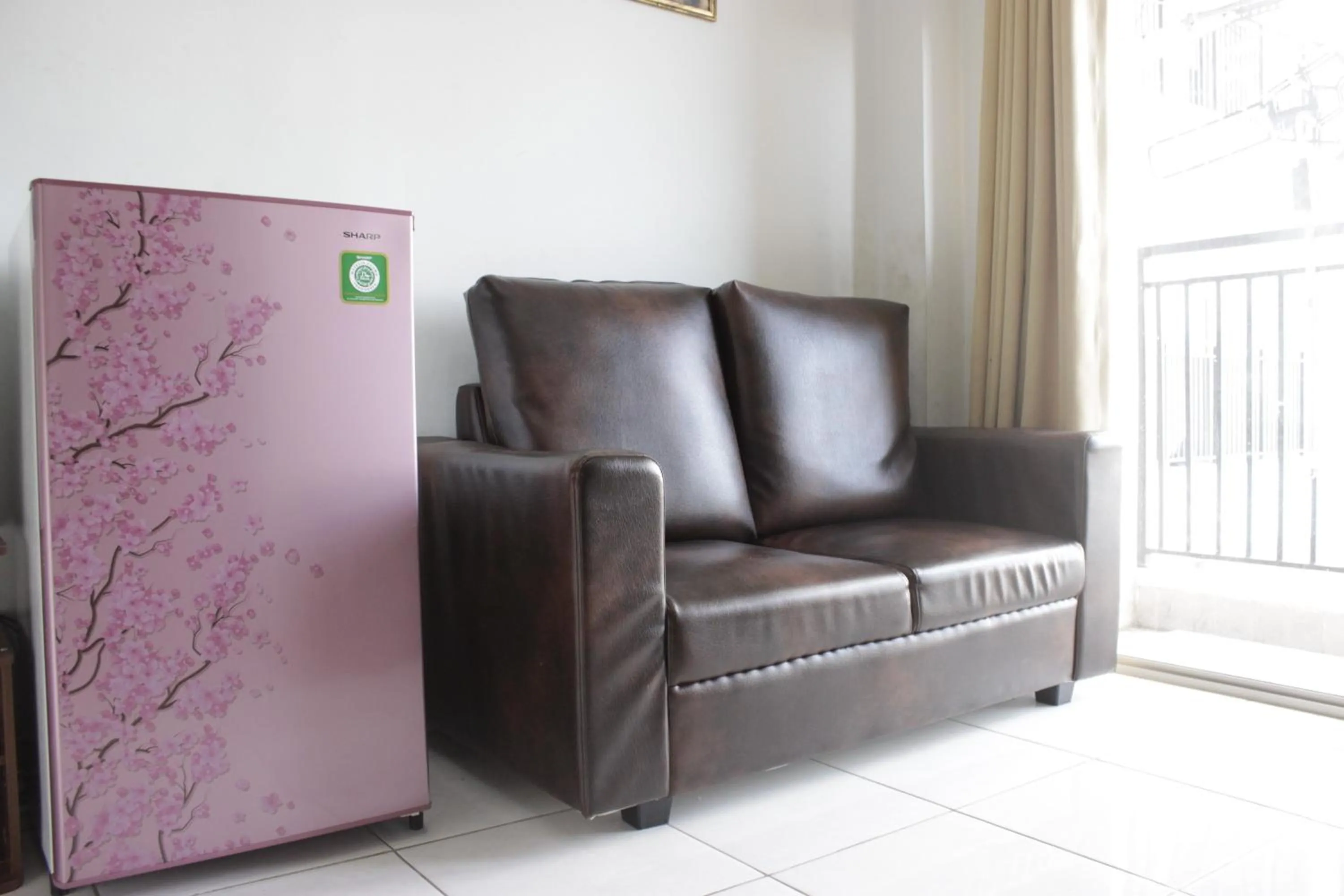 Living room in Comfy 2BR Apartment at Mekarwangi Square Cibaduyut By Travelio