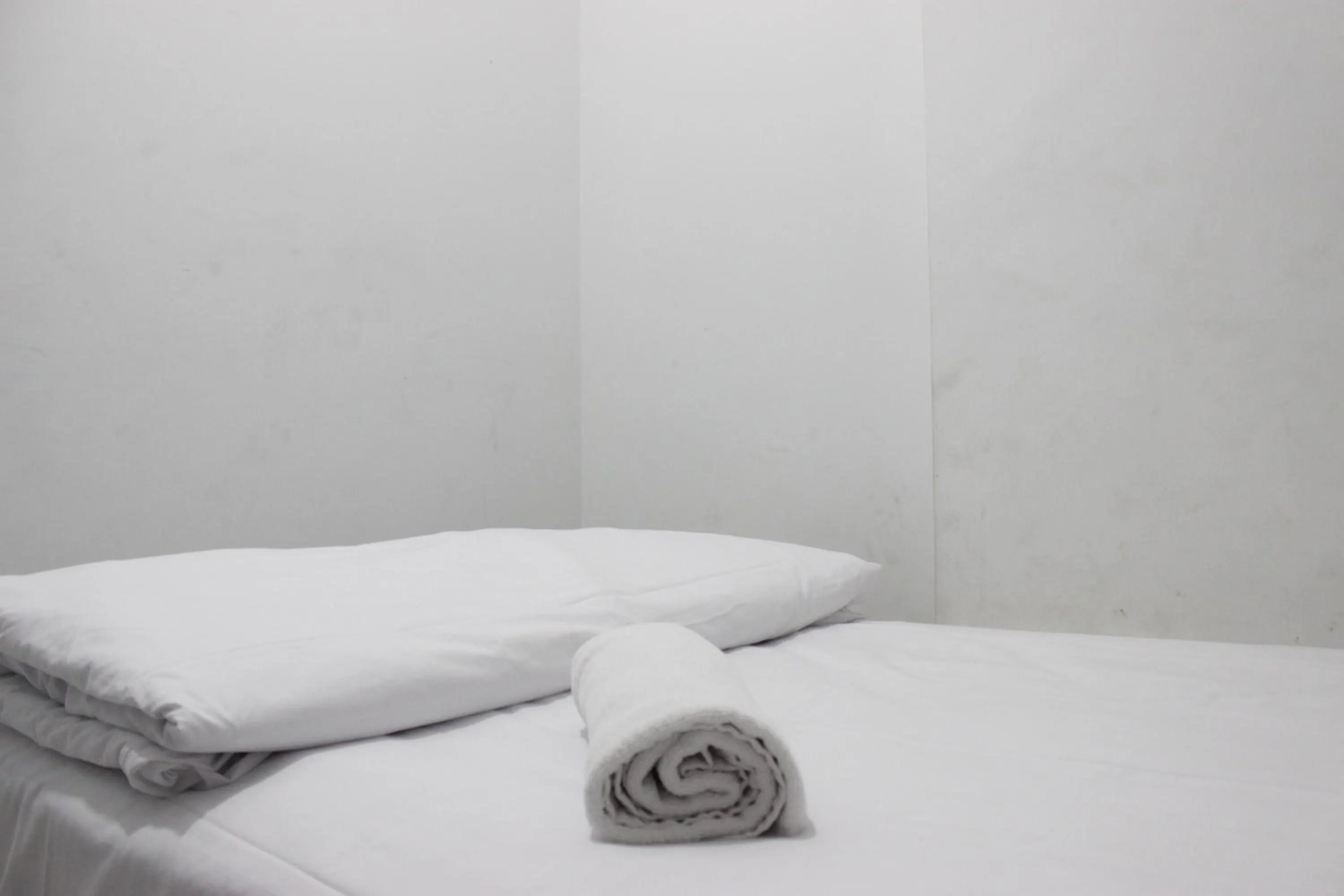 Bed in Comfy 2BR Apartment at Mekarwangi Square Cibaduyut By Travelio