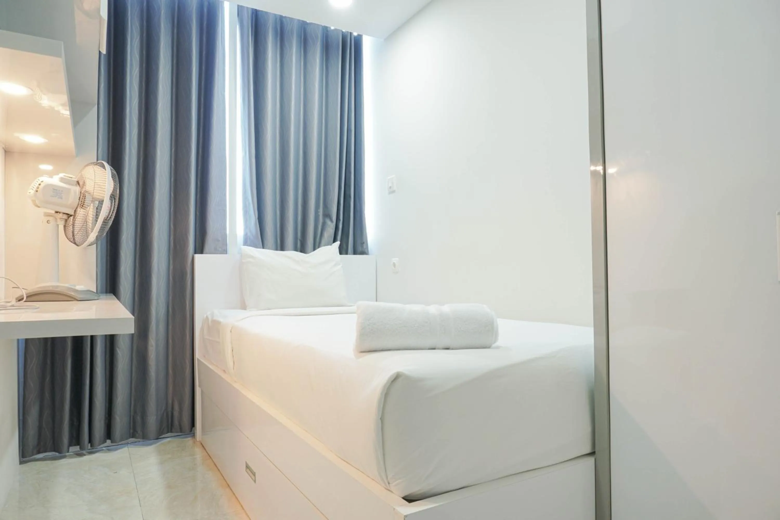 Bed in Fully Furnished with Comfortable Design 2BR Harco Mangga Besar Apartment By Travelio