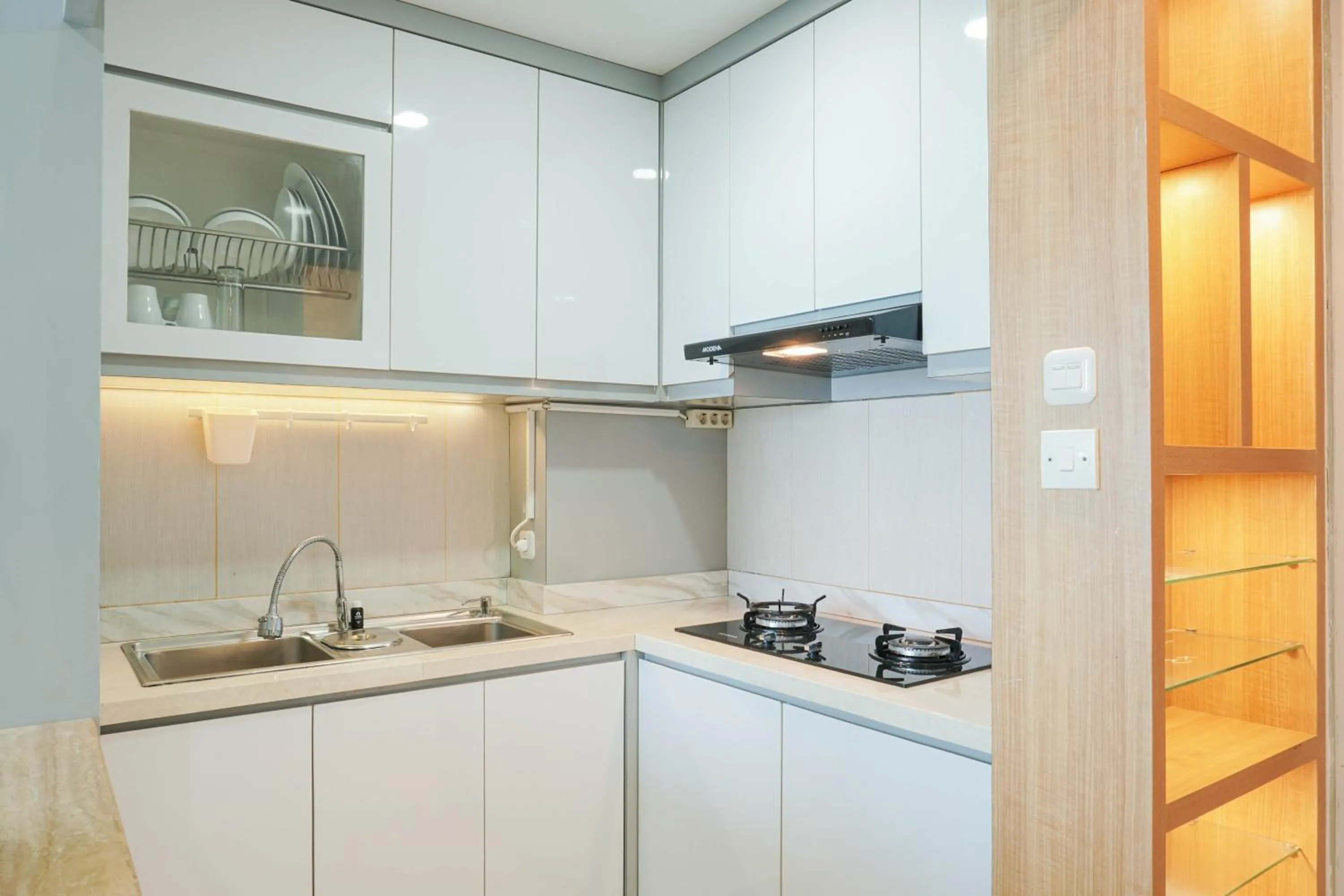 Kitchen or kitchenette in Fully Furnished with Comfortable Design 2BR Harco Mangga Besar Apartment By Travelio