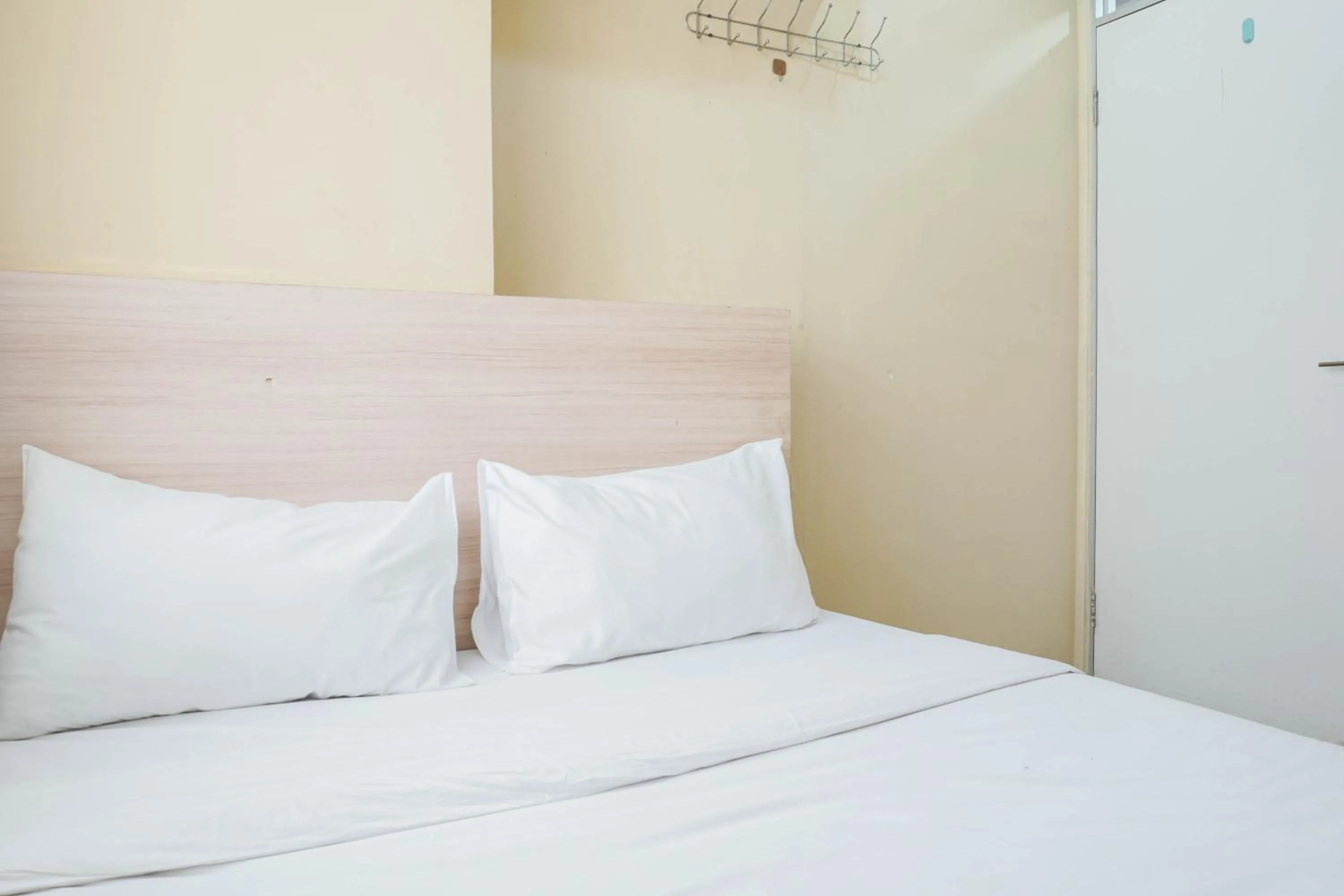 Bed in Comfy and Strategic 2BR at Menteng Square Apartment By Travelio