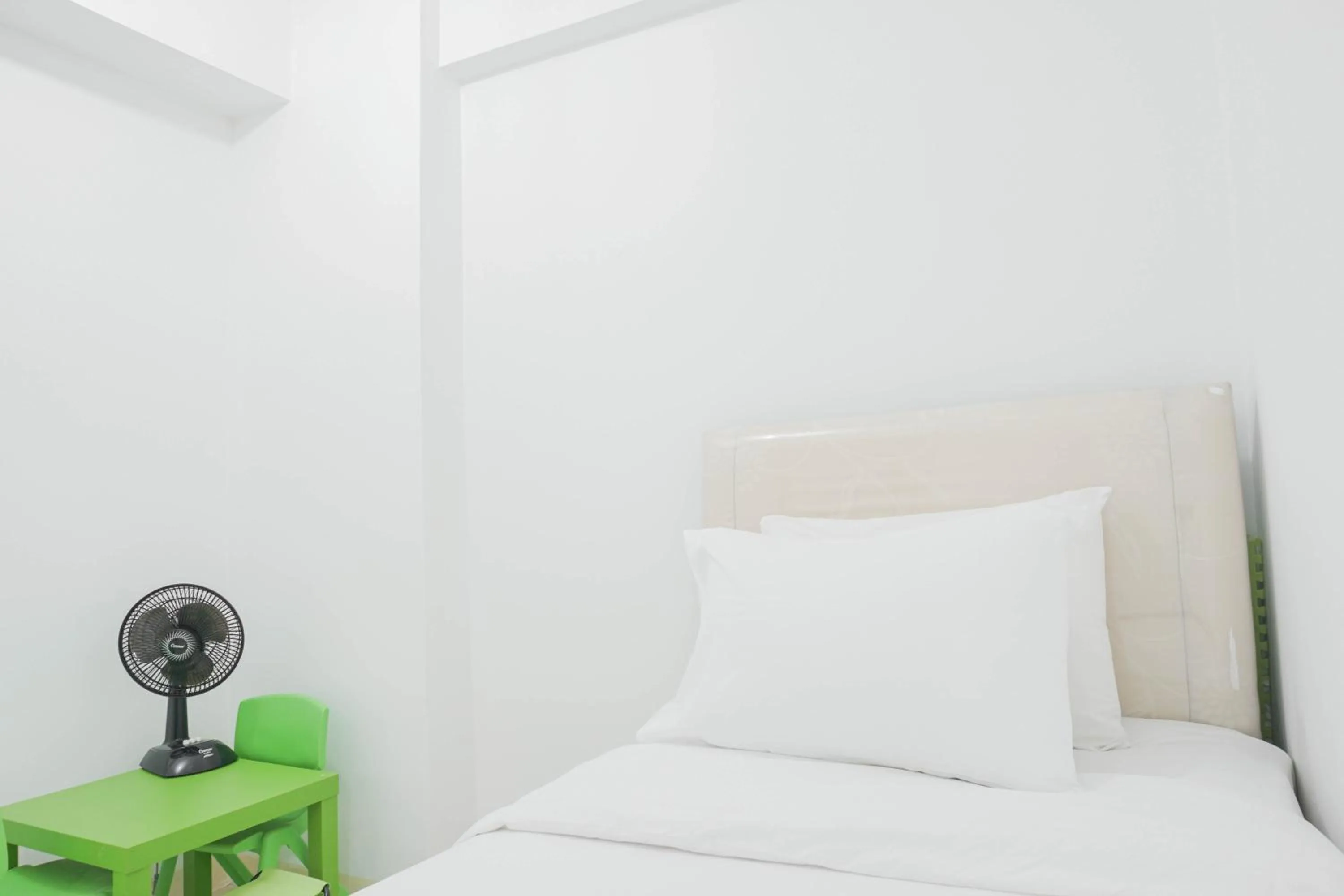 Bed in Elegant 2BR at Bassura City Apartment By Travelio