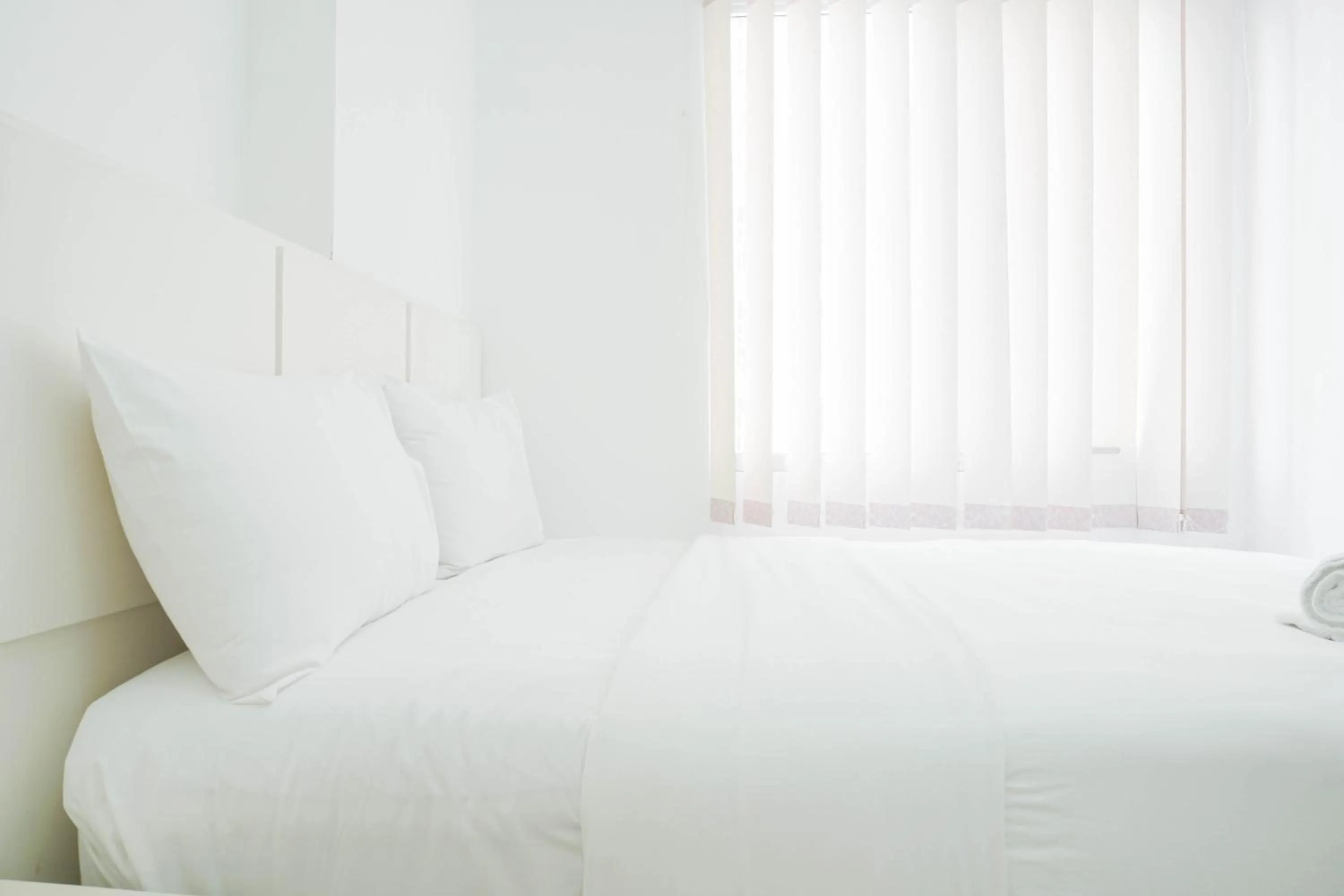 Bed in Elegant 2BR at Bassura City Apartment By Travelio