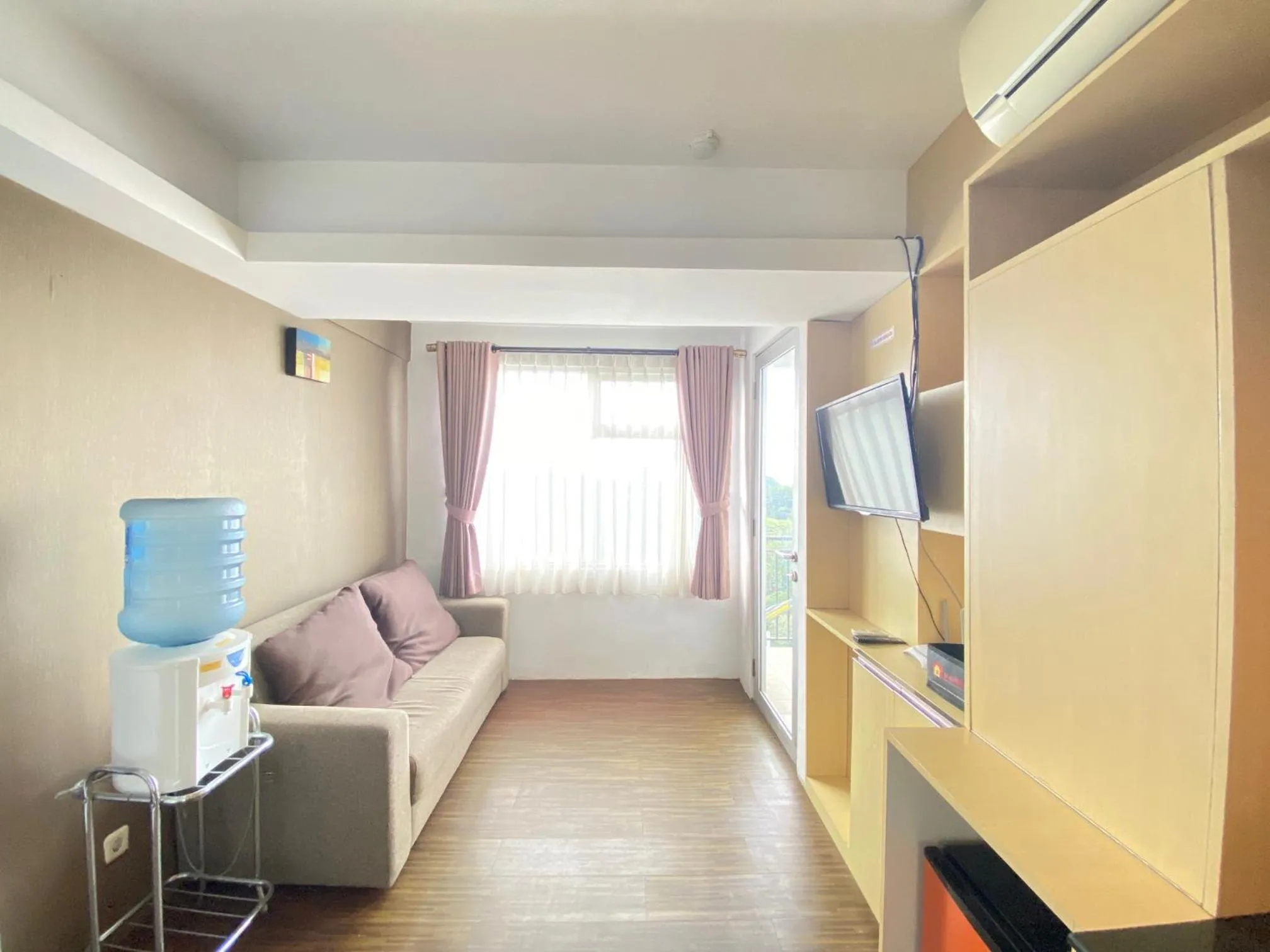 Living room in Quite 2BR Apartment AC in Living Room at The Jarrdin Cihampelas By Travelio