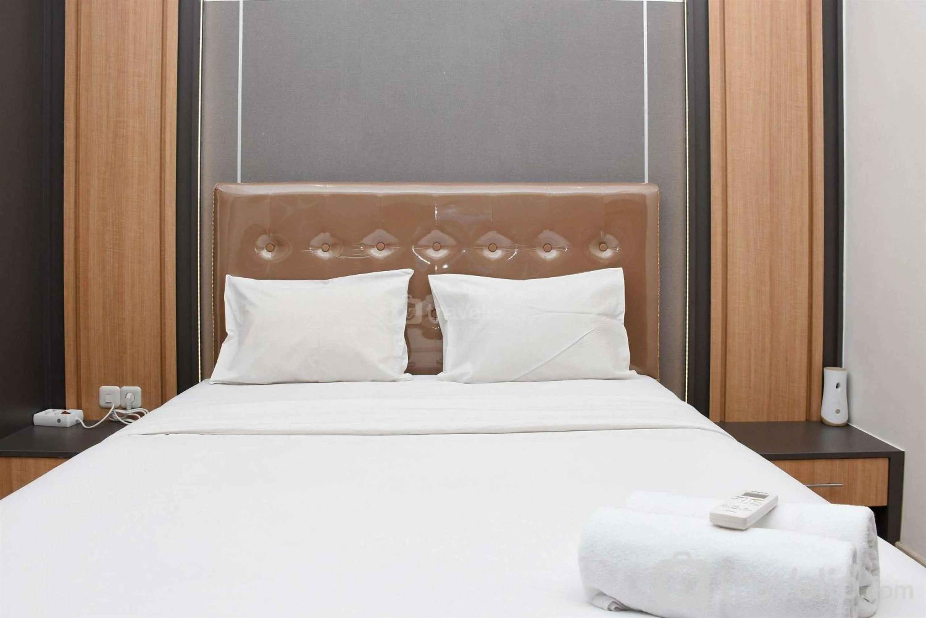 Bed in Cozy Living Studio at Menteng Park Apartment By Travelio