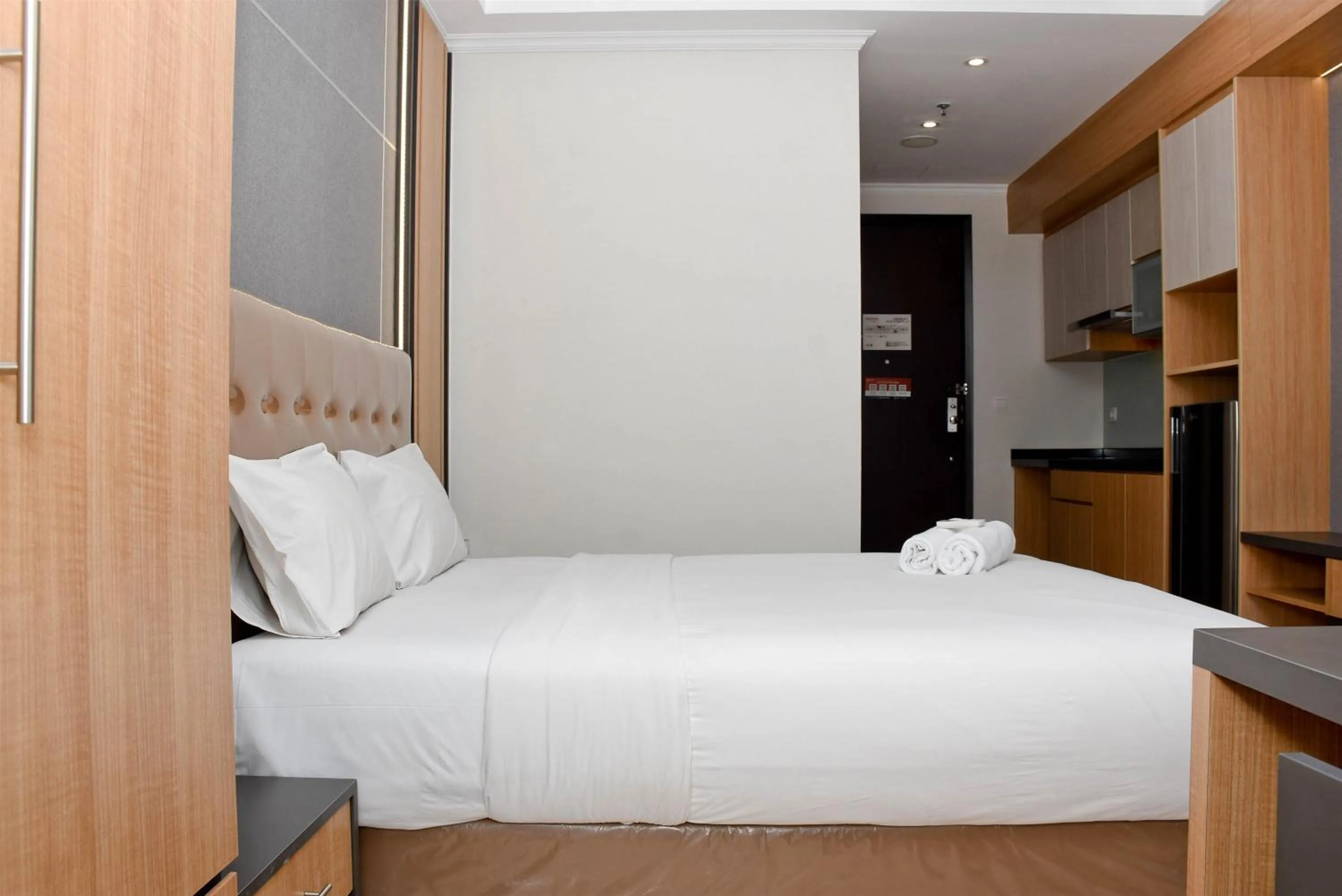 Bed in Cozy Living Studio at Menteng Park Apartment By Travelio