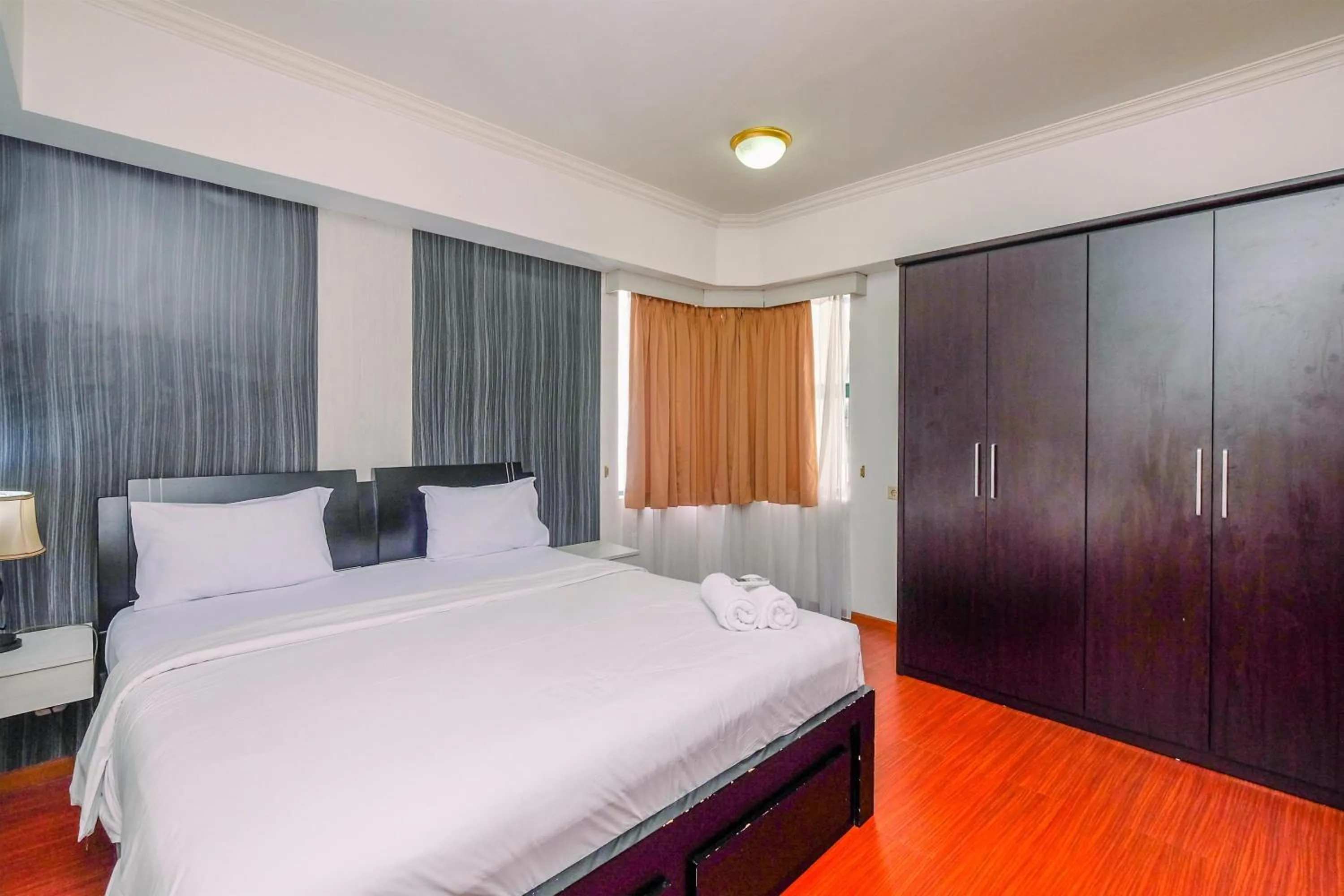 Bed in Comfort 2BR + Extra Room at Sudirman Tower Condominium Apartment By Travelio