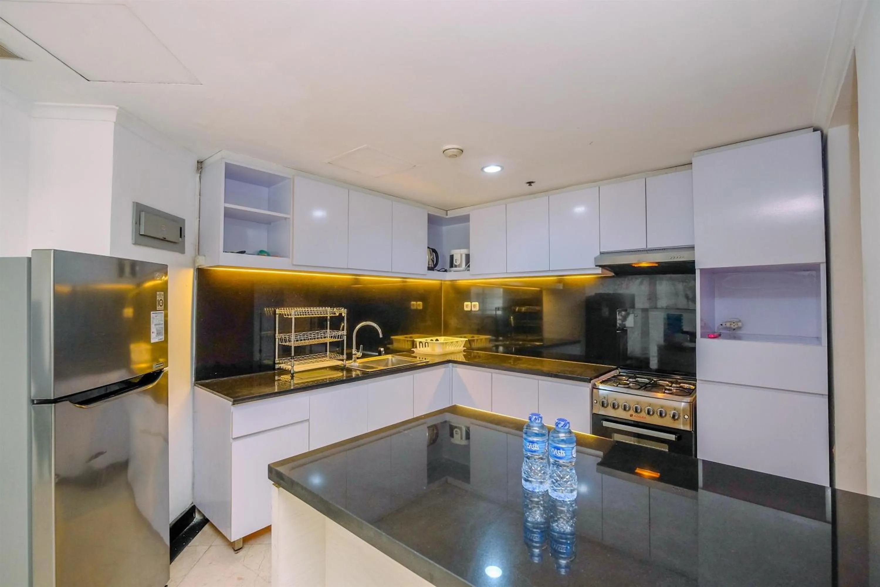 Kitchen or kitchenette in Comfort 2BR + Extra Room at Sudirman Tower Condominium Apartment By Travelio