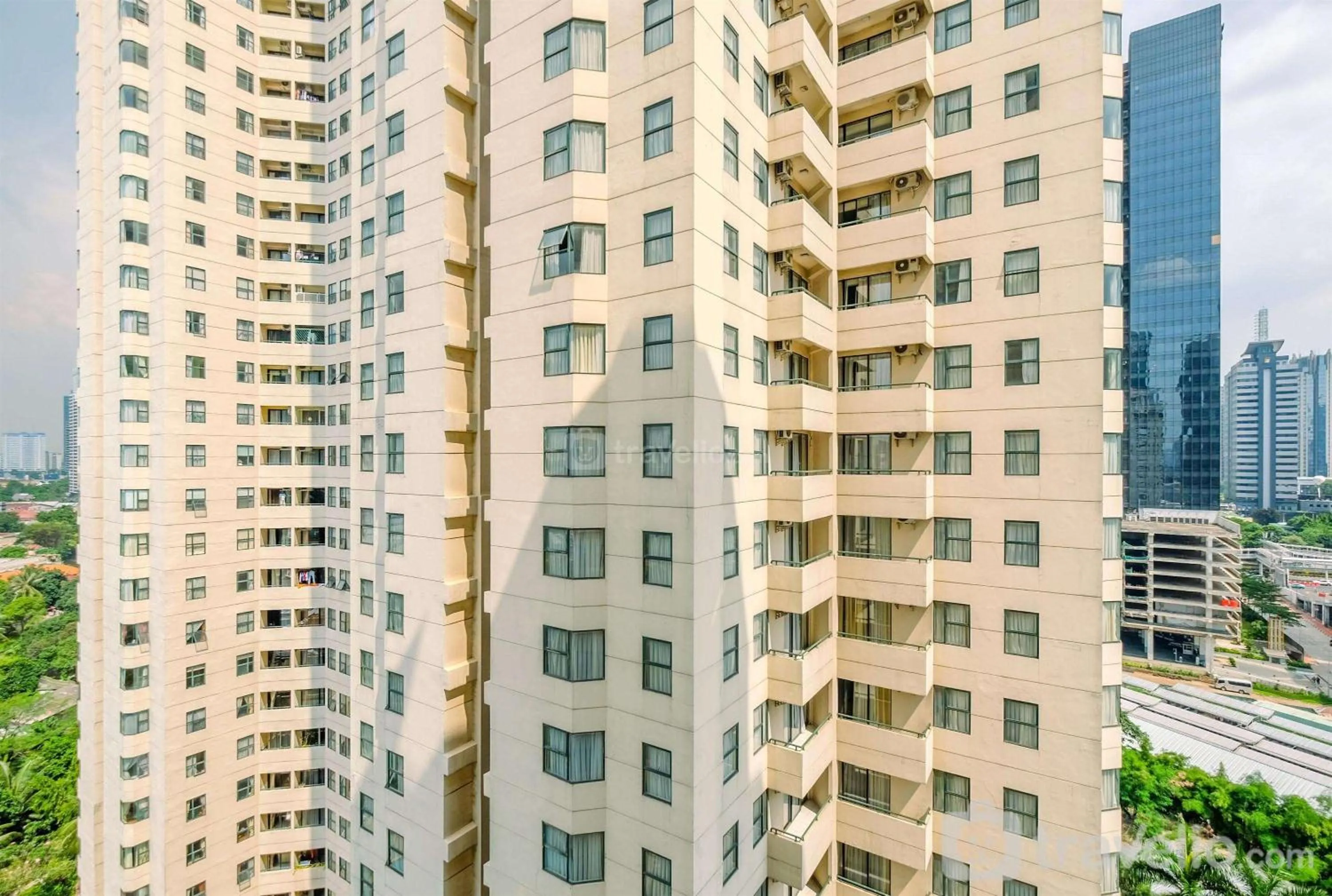 Property building in Comfort 2BR + Extra Room at Sudirman Tower Condominium Apartment By Travelio