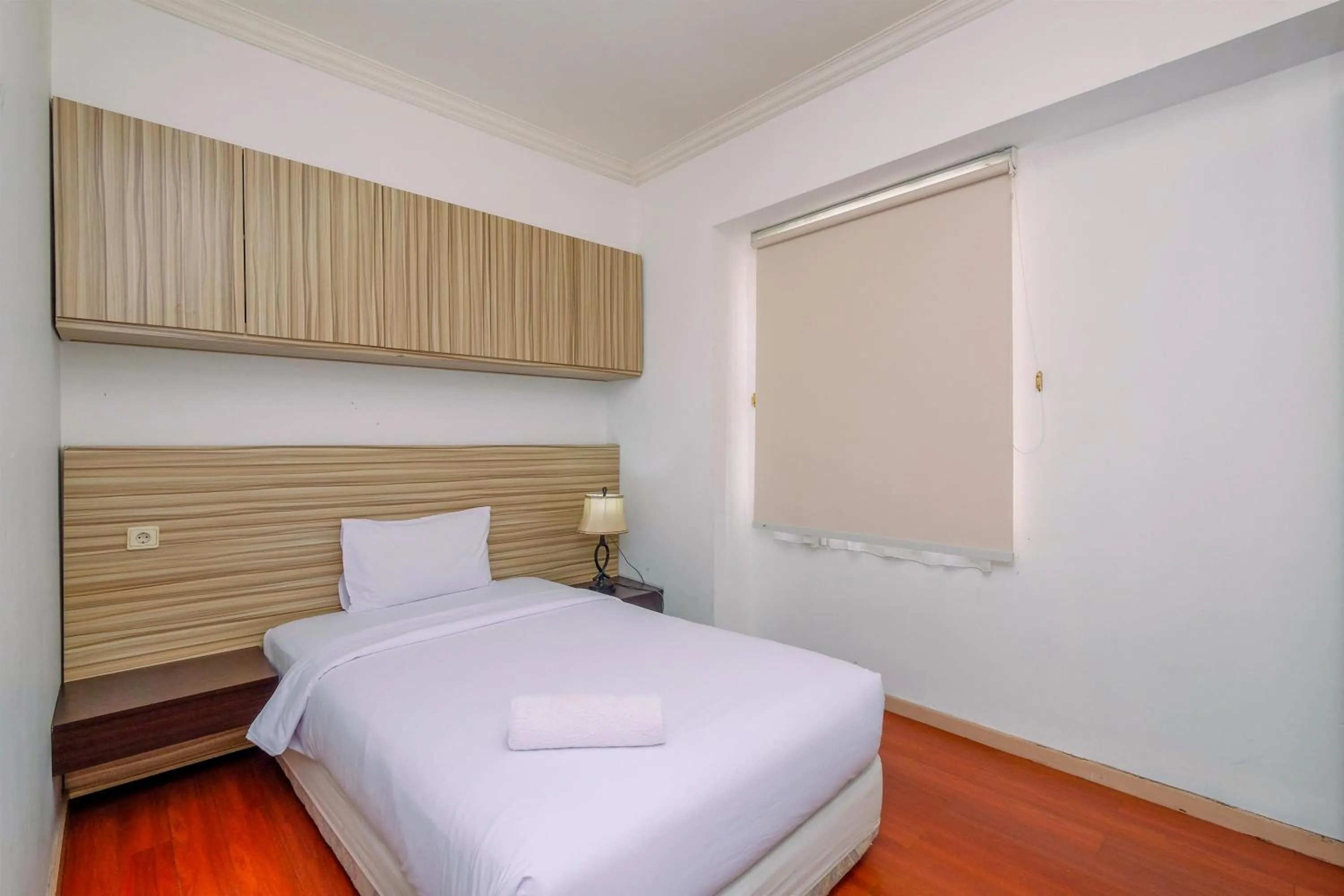 Bed in Comfort 2BR + Extra Room at Sudirman Tower Condominium Apartment By Travelio