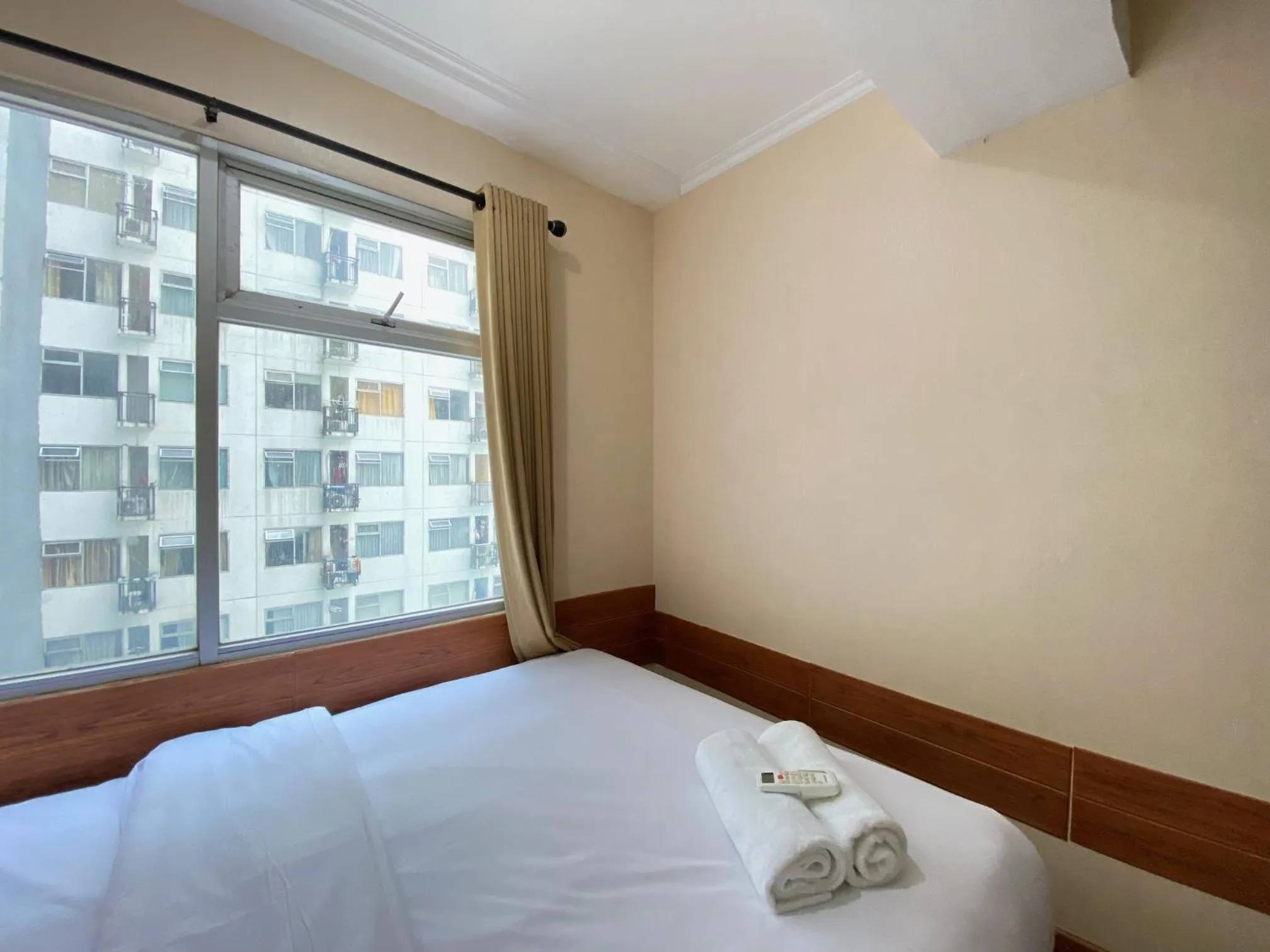 Bed in Cozy Living 2BR Apartment at Jarrdin Cihampelas By Travelio