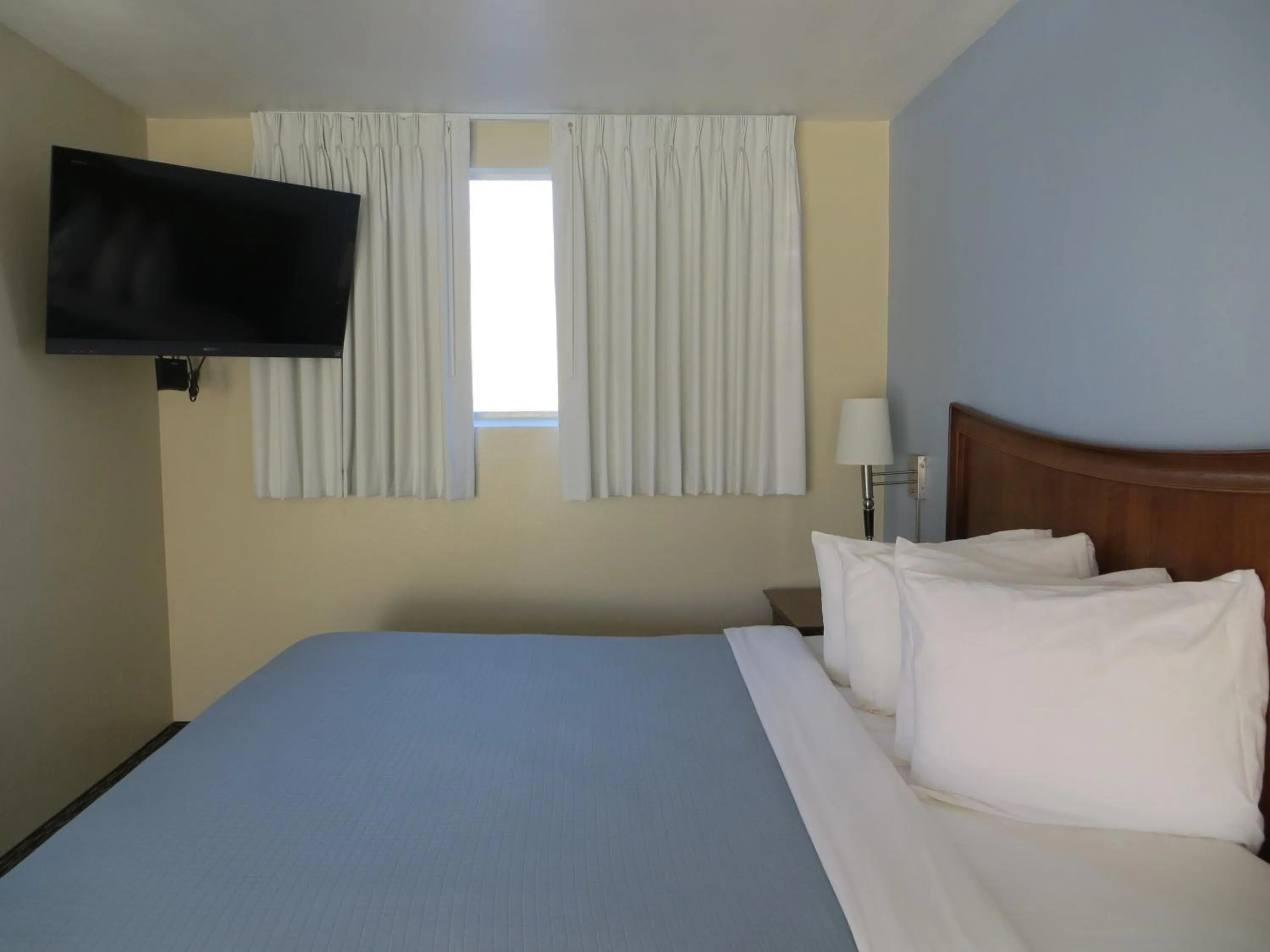 Bed in Coronet Motel