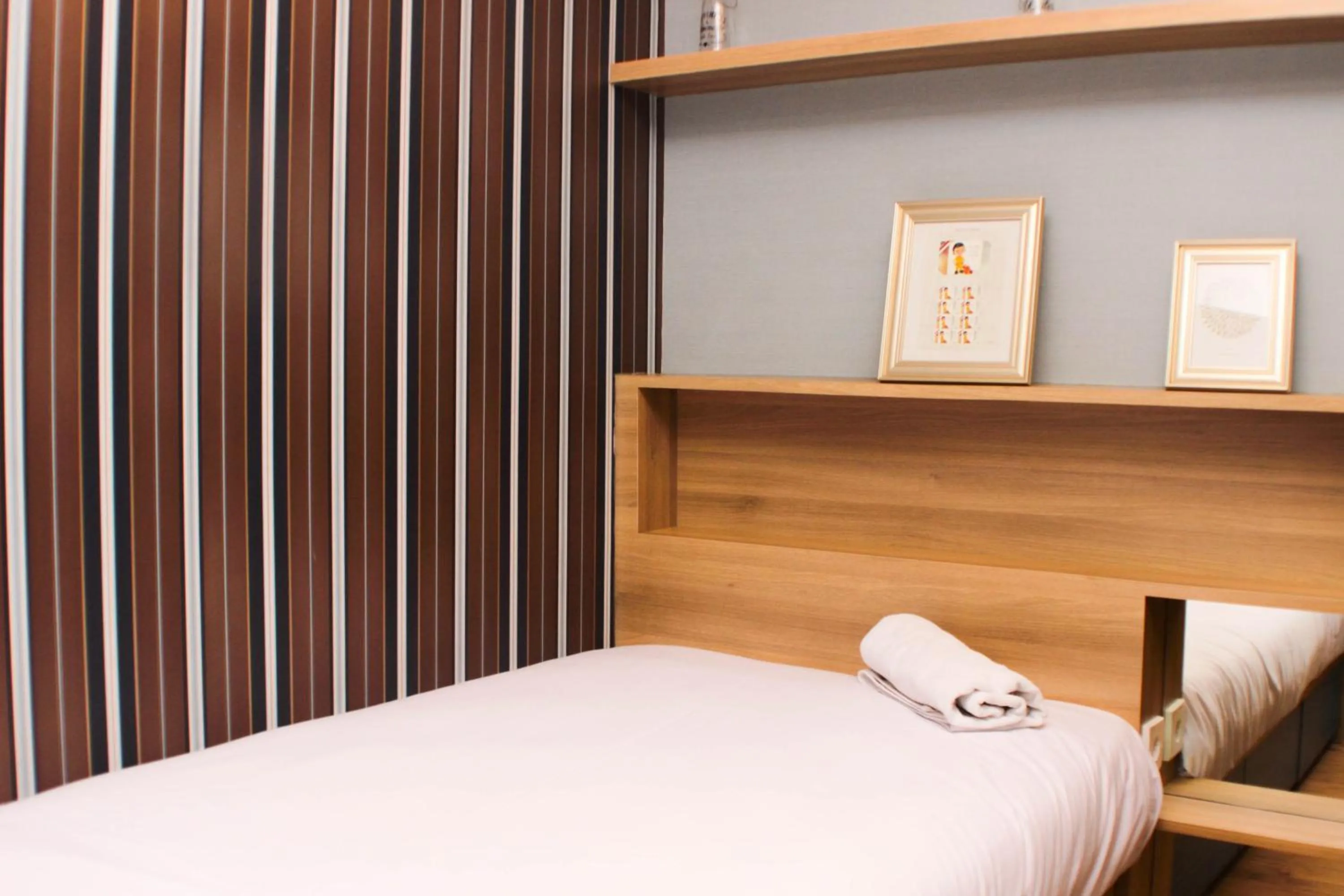 Bed in Strategic and Simply 2BR at Bassura City Apartment By Travelio