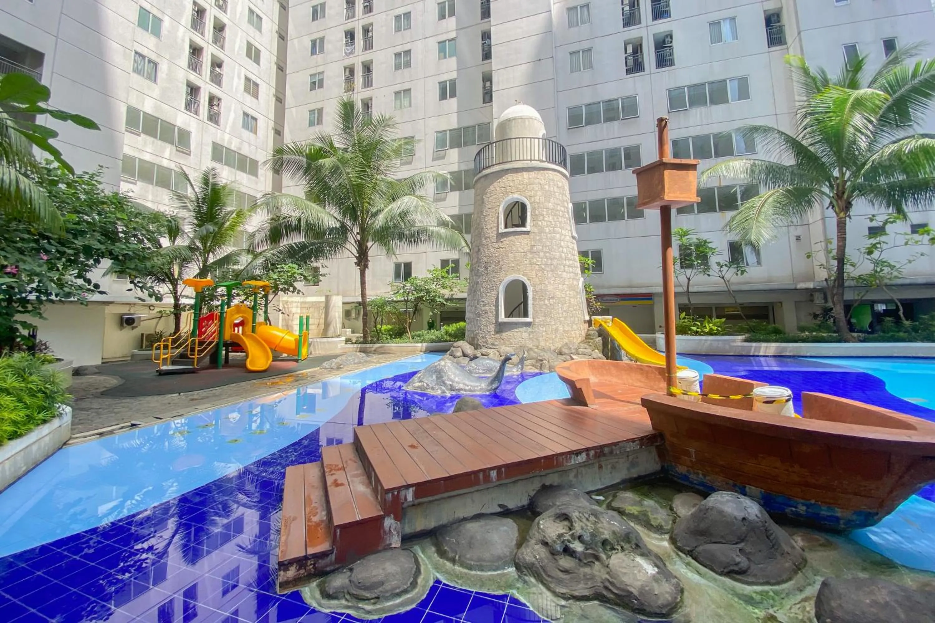 Swimming pool in Strategic and Simply 2BR at Bassura City Apartment By Travelio