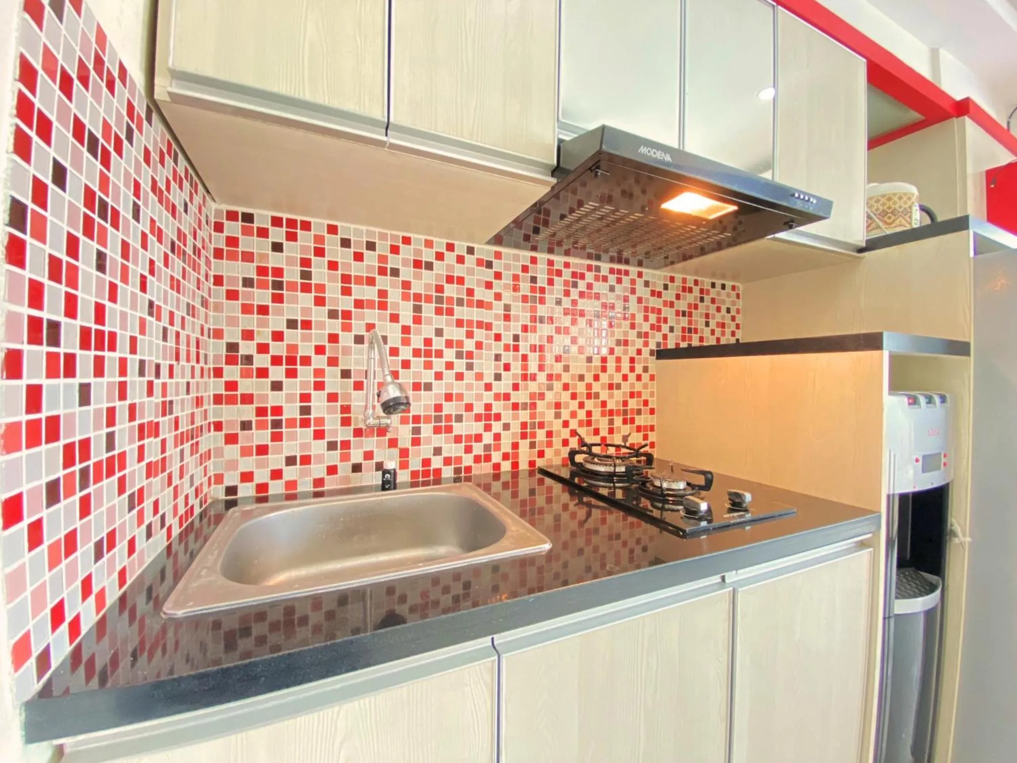 Kitchen or kitchenette in Spacious 2BR at Jarrdin Cihampelas Apartment By Travelio