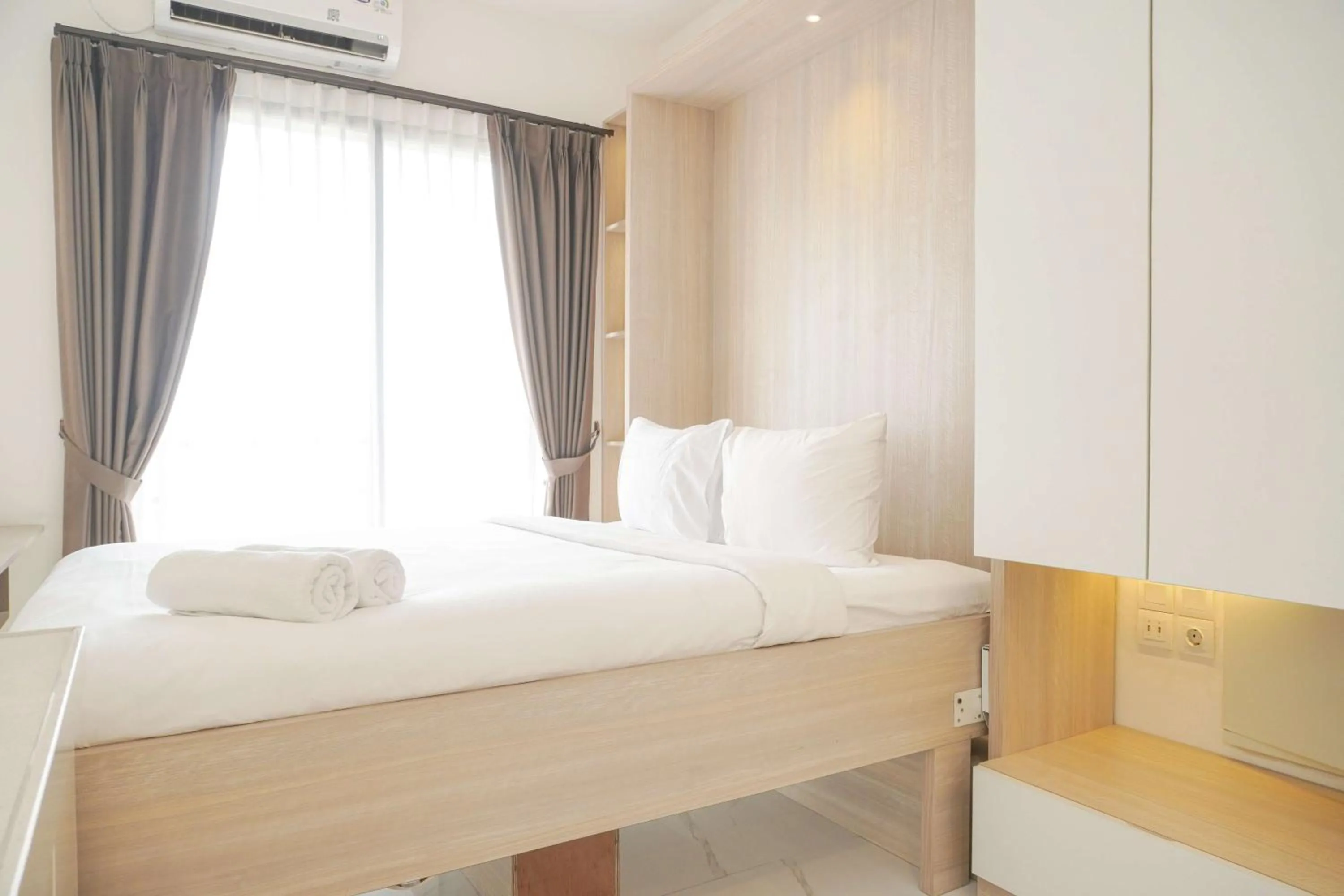 Bed in Best Choice and Nice Studio at Sky House BSD Apartment By Travelio