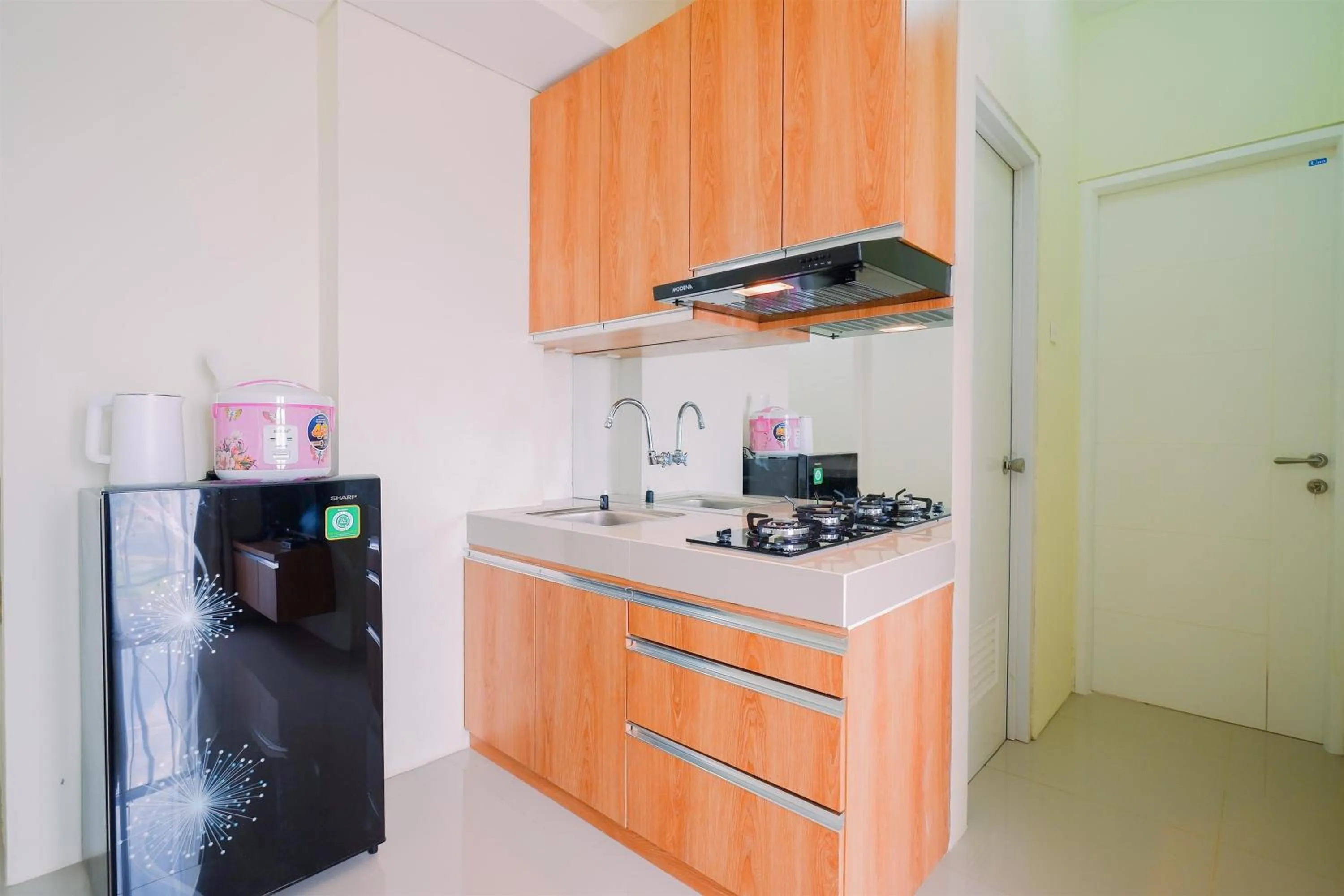 kitchen in Warm and Cozy Living 2BR Bogorienze Apartment By Travelio