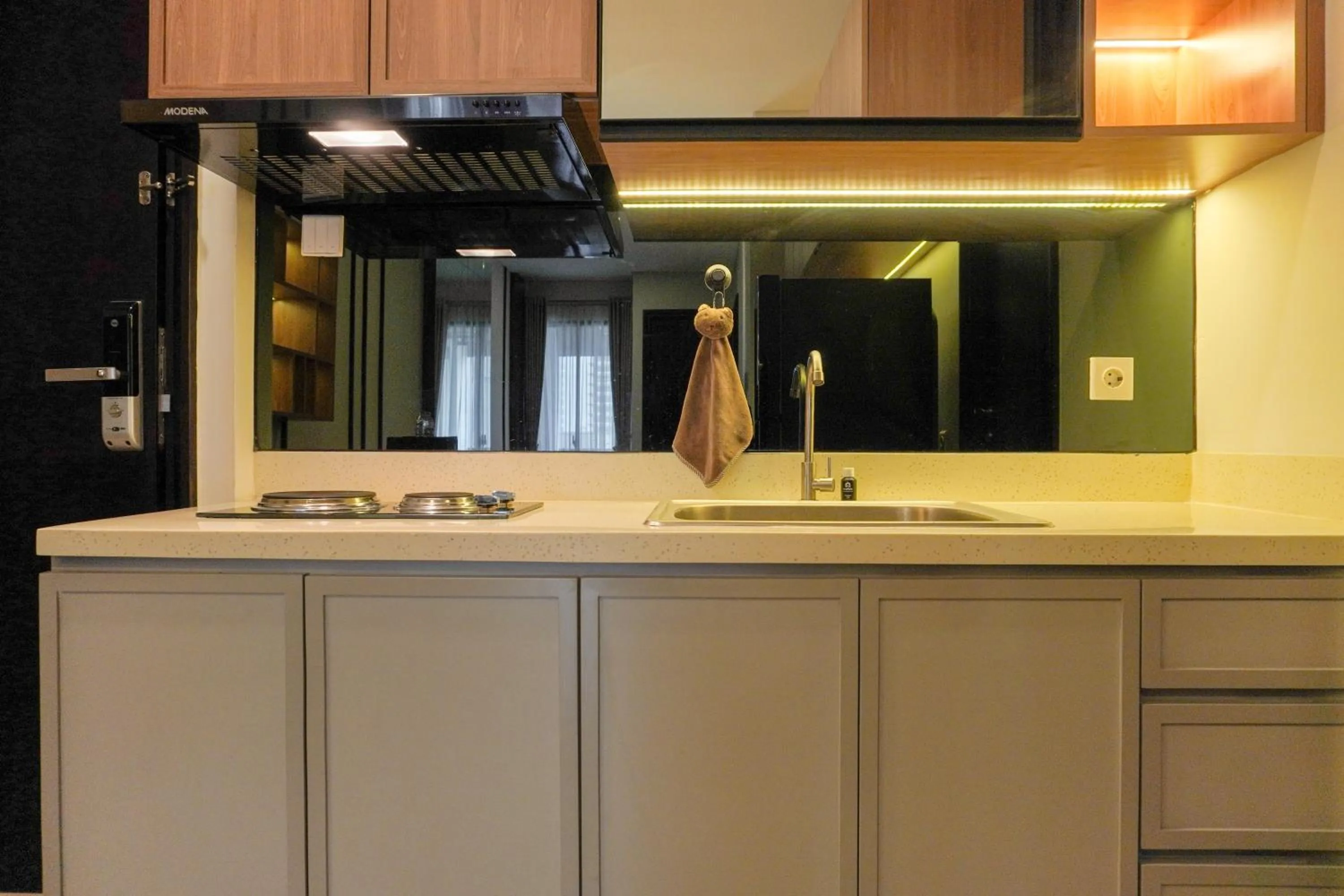 Kitchen or kitchenette in Comfort and Elegant 2BR Sudirman Suites Apartment By Travelio