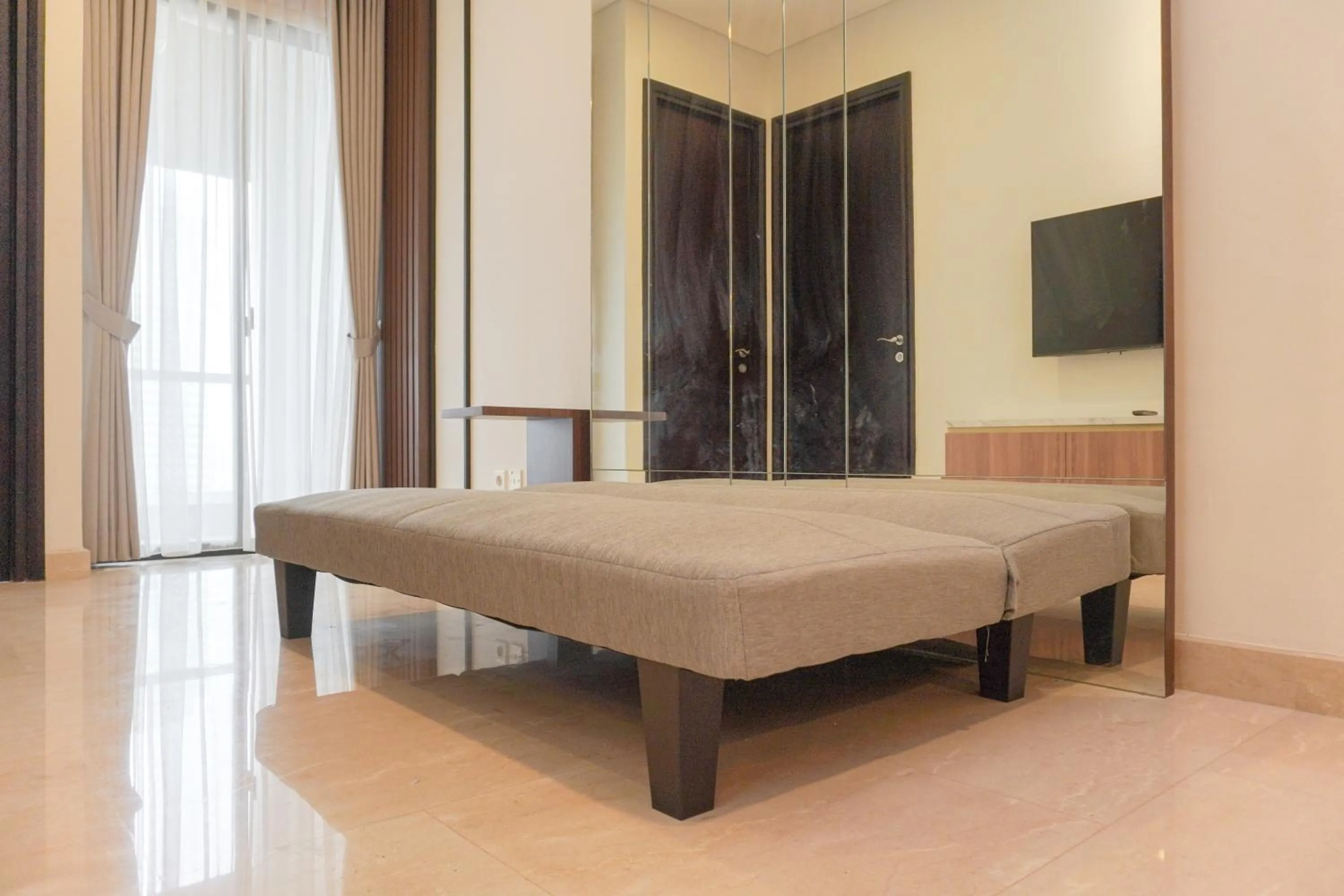 Living room, Bed in Comfort and Elegant 2BR Sudirman Suites Apartment By Travelio