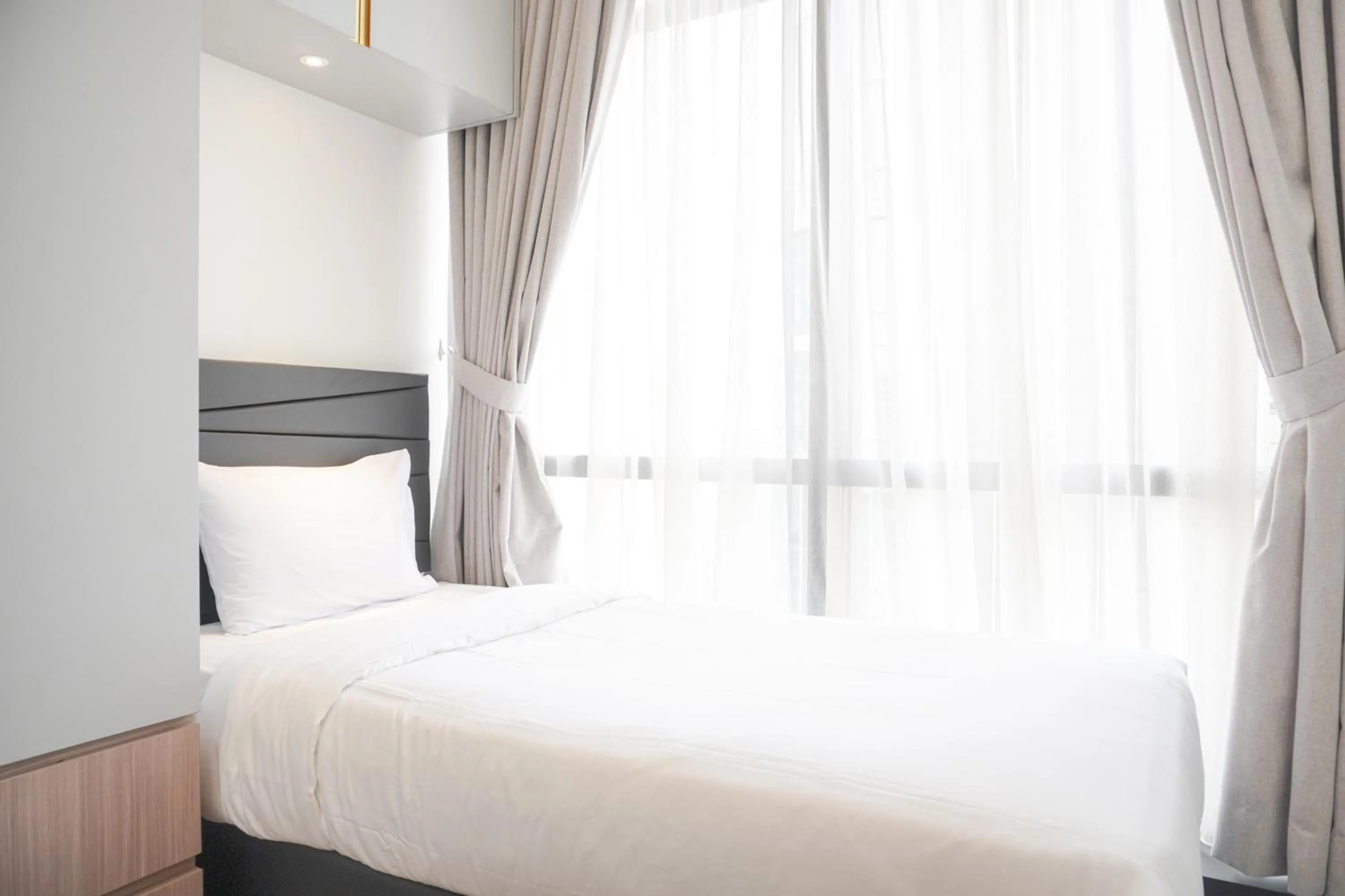 Bed in Comfort and Elegant 2BR Sudirman Suites Apartment By Travelio