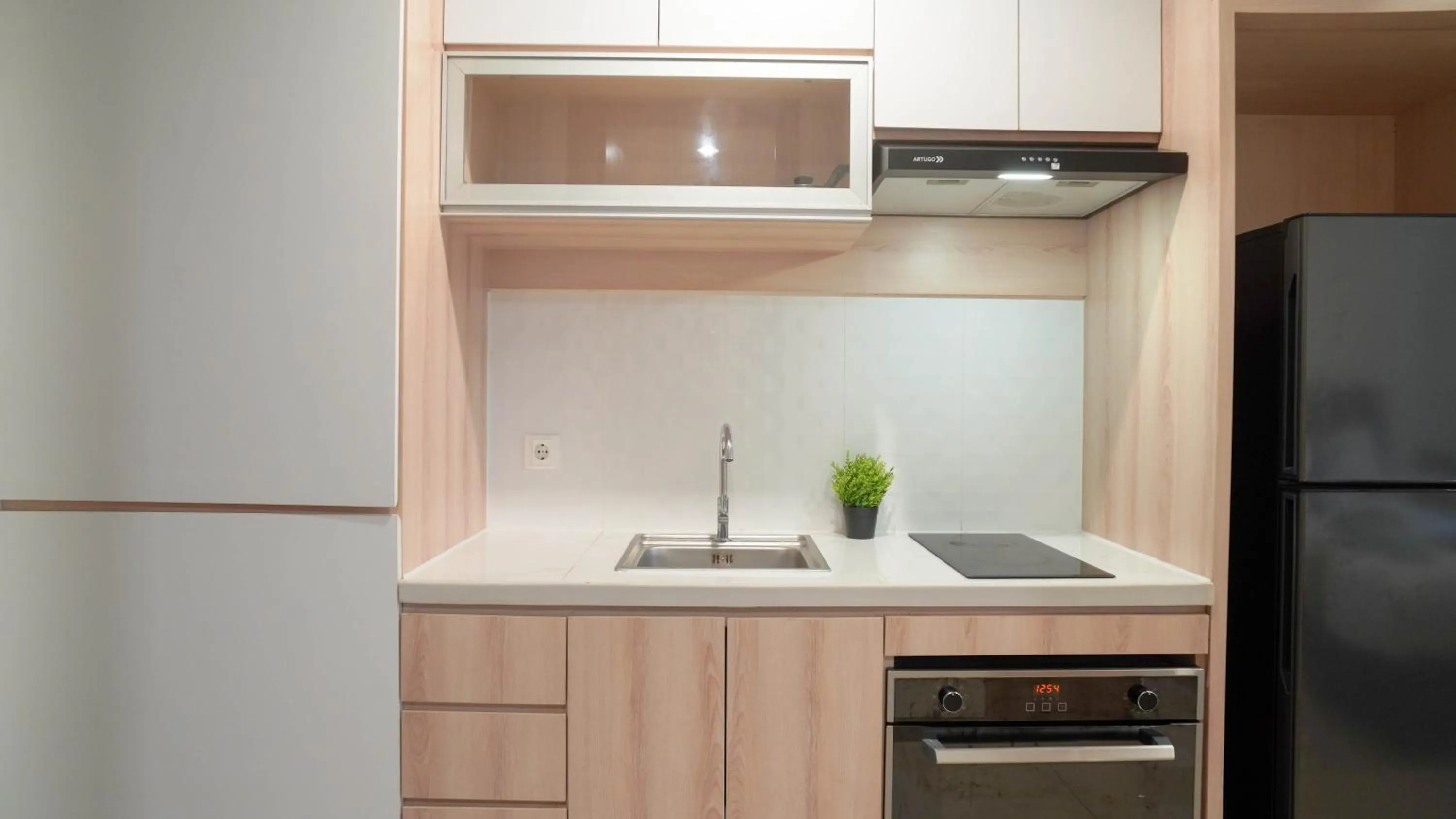 Kitchen or kitchenette in Spacious and Homey Studio at Cleon Park Apartment By Travelio