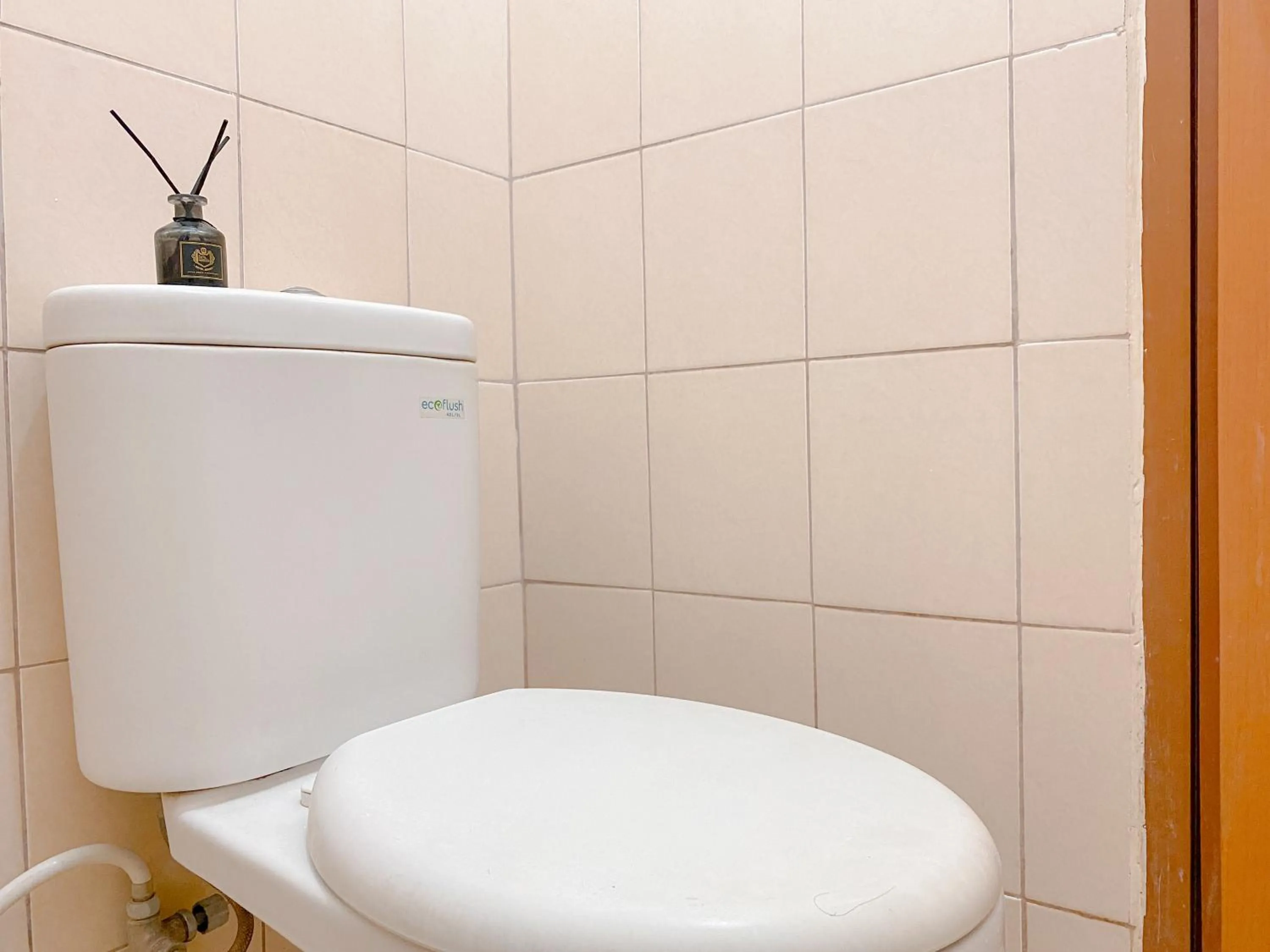 Toilet in Modern Look and Comfy Studio Tifolia Apartment By Travelio