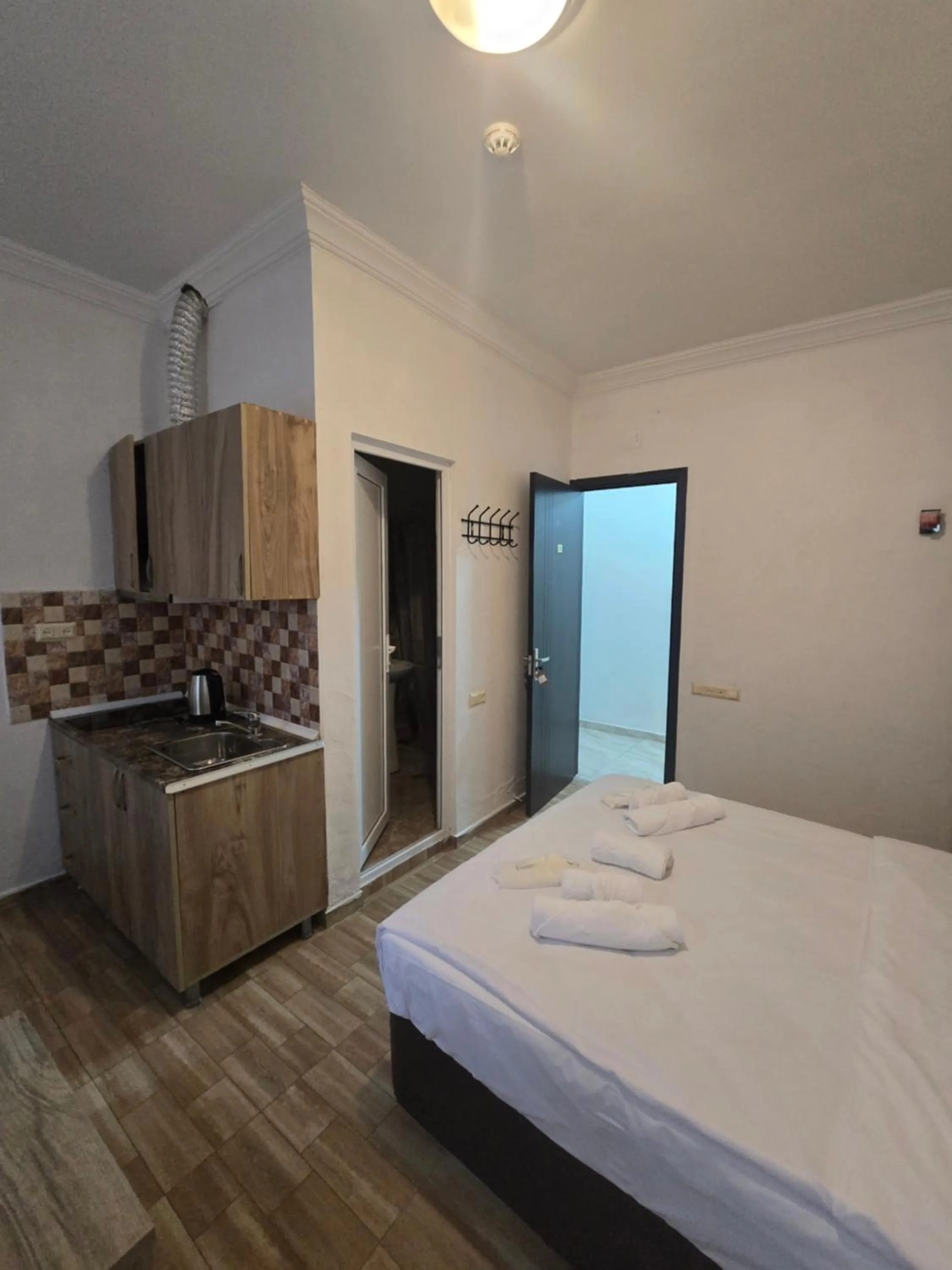 Kitchen or kitchenette, Bed in Batumi Inn Hotel