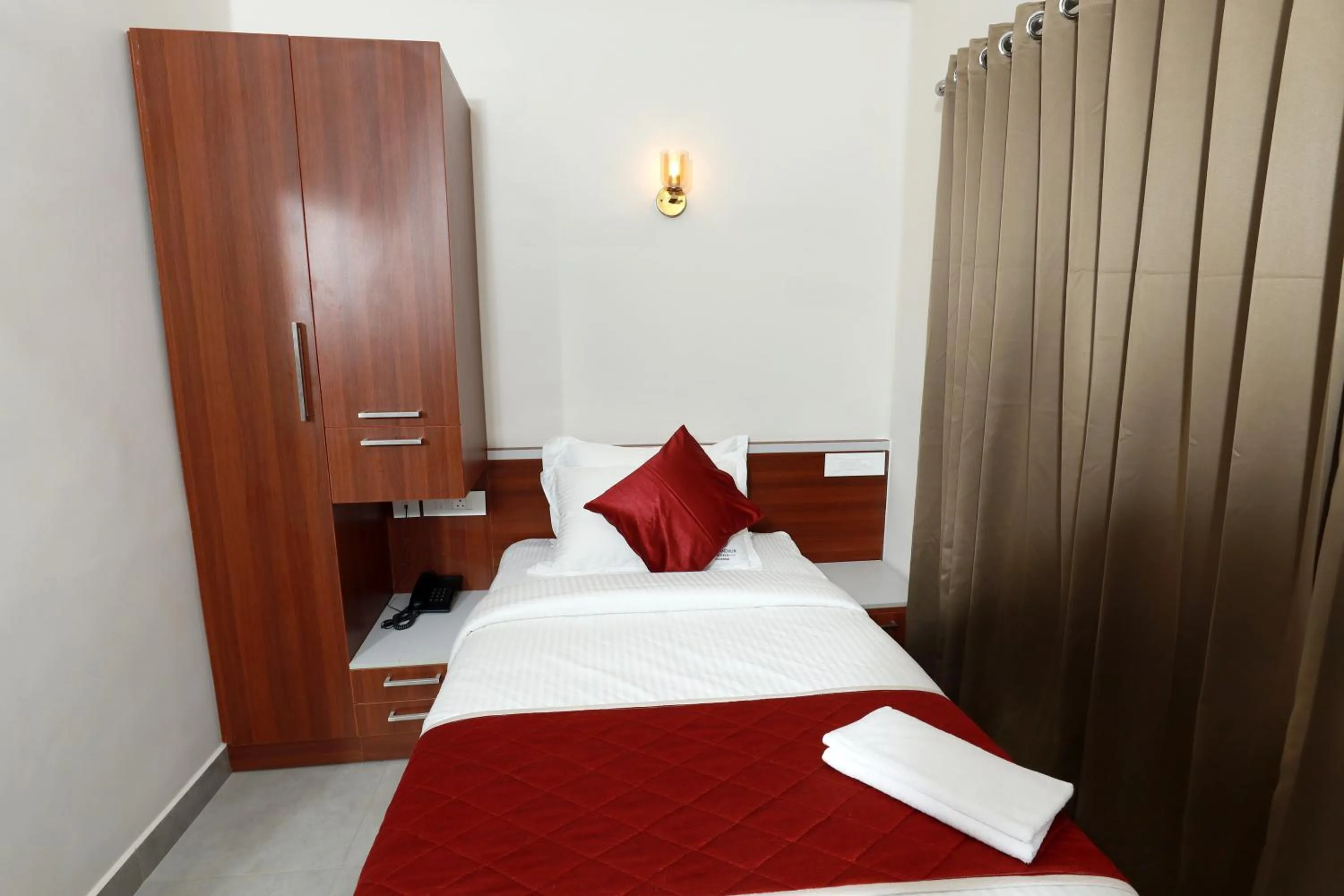wardrobe, Bed in K Grandeur Hotels