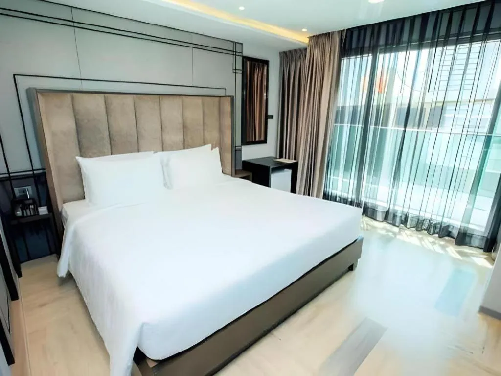 Bed in First Pride Hotel Bangkok