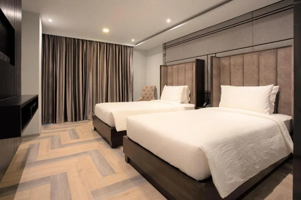 Bed in First Pride Hotel Bangkok