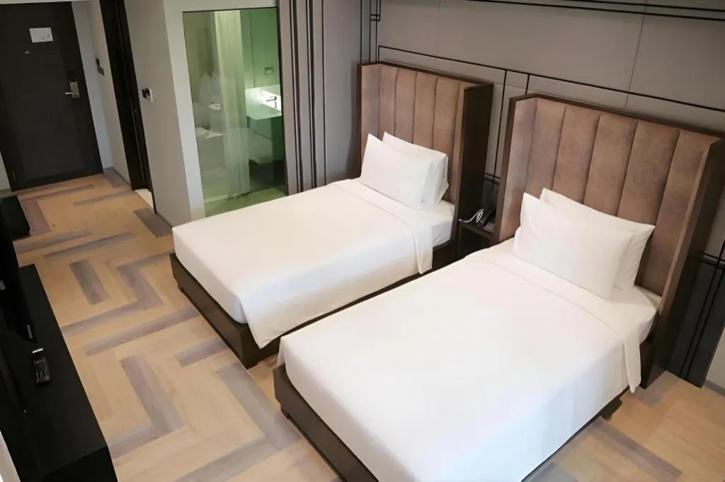 Bed in First Pride Hotel Bangkok