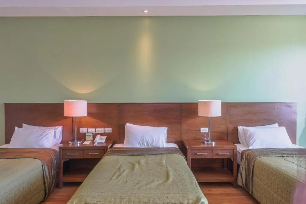 Bed in Mansion Garden Hotel