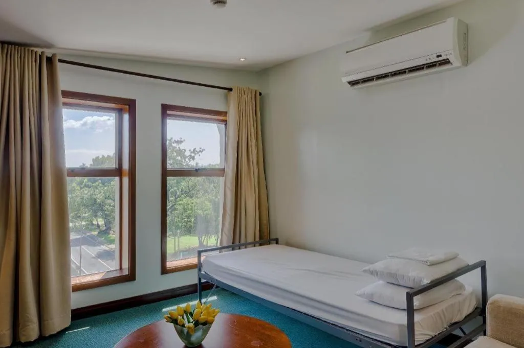 Bed in Mansion Garden Hotel