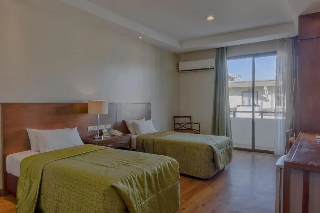 Bed in Mansion Garden Hotel