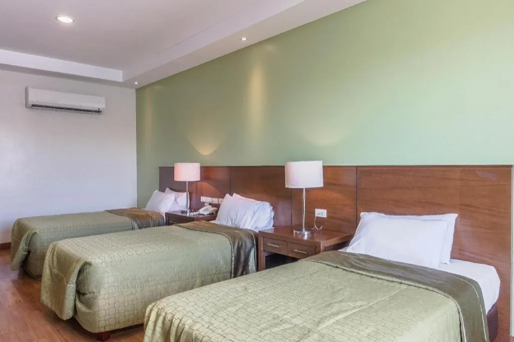 Bed in Mansion Garden Hotel