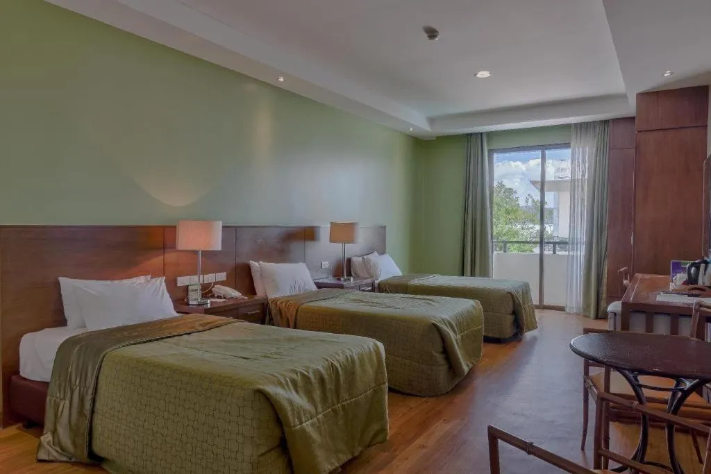 Bed in Mansion Garden Hotel