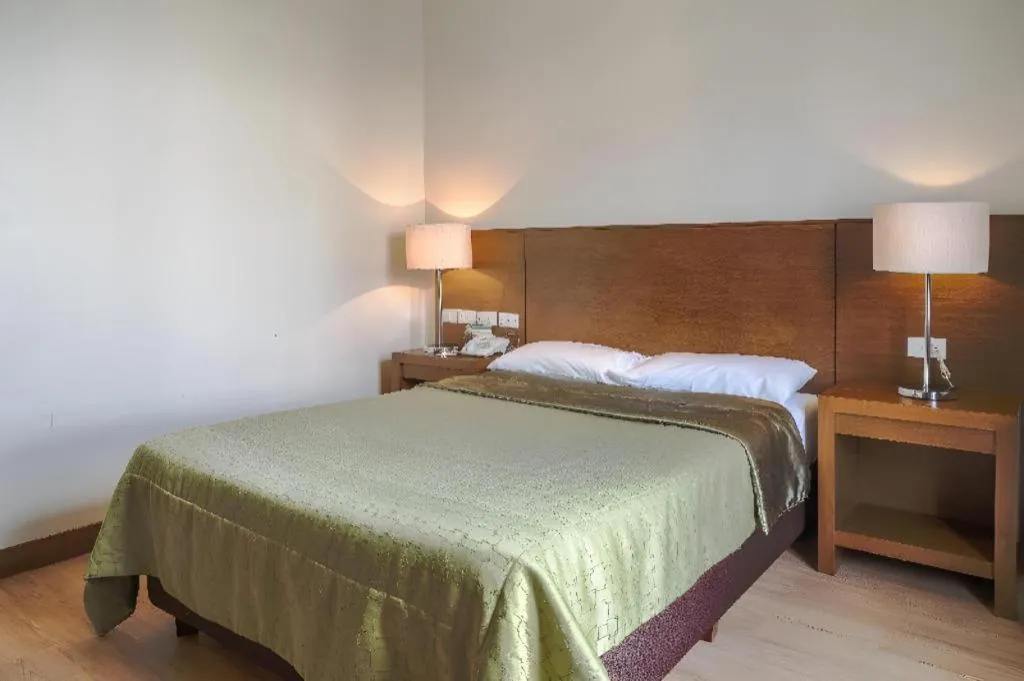 Bed in Mansion Garden Hotel