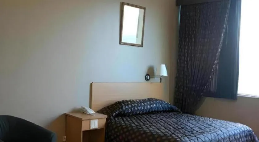 Bed in Great Eastern Hotel Quezon City