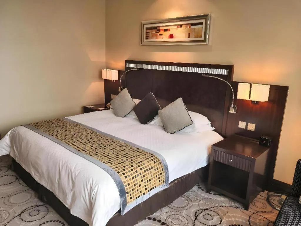 Bed in Grand Soluxe Zhongyou Hotel