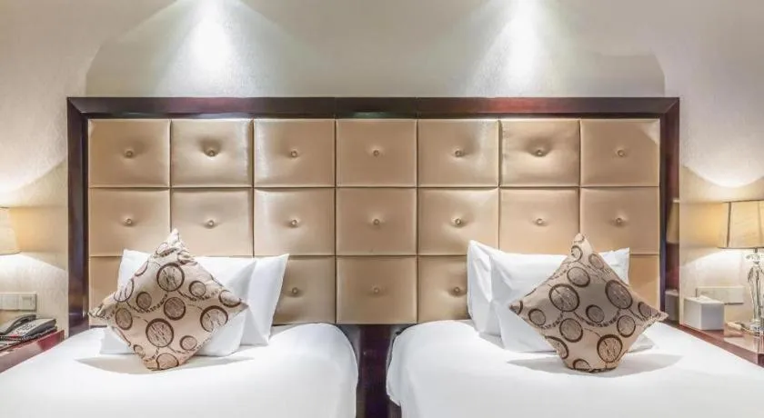 Bed in New Century Grand Hotel Xinxiang