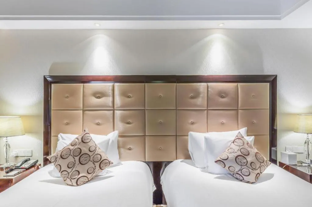 Bed in New Century Grand Hotel Xinxiang