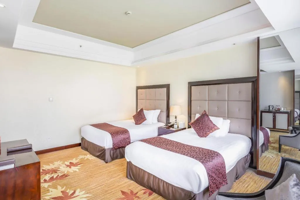 Bed in New Century Grand Hotel Xinxiang