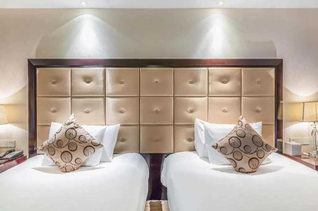 Bed in New Century Grand Hotel Xinxiang