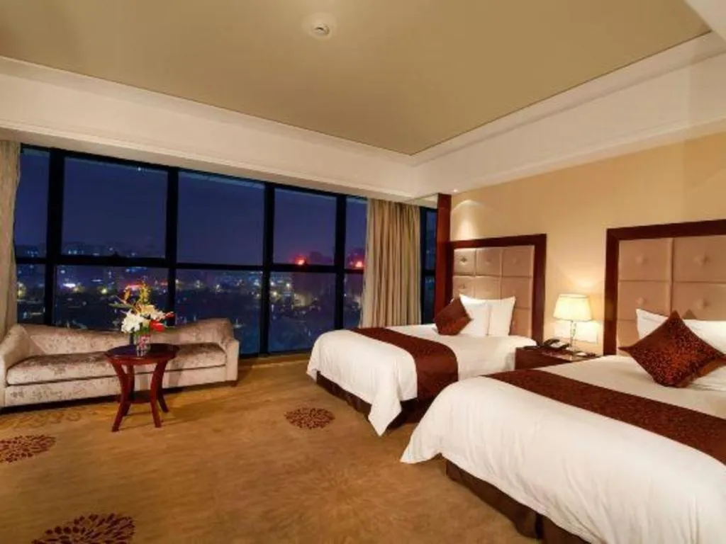 Bed in New Century Grand Hotel Xinxiang