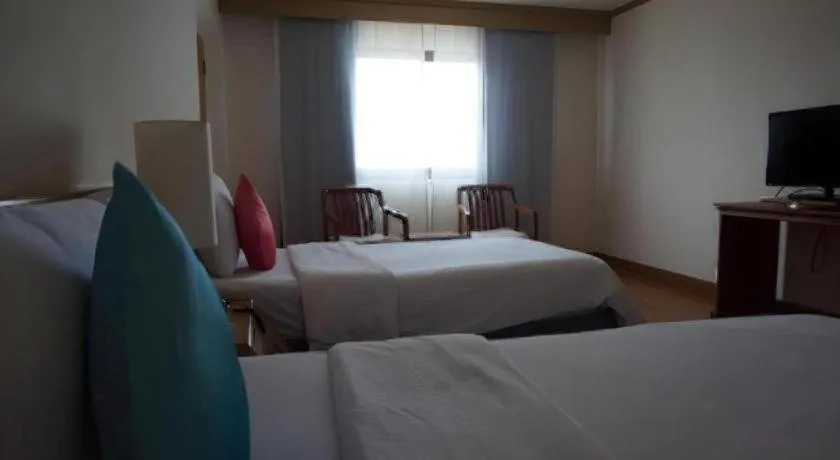 Bed in The Majestic Sakon Nakhon Hotel