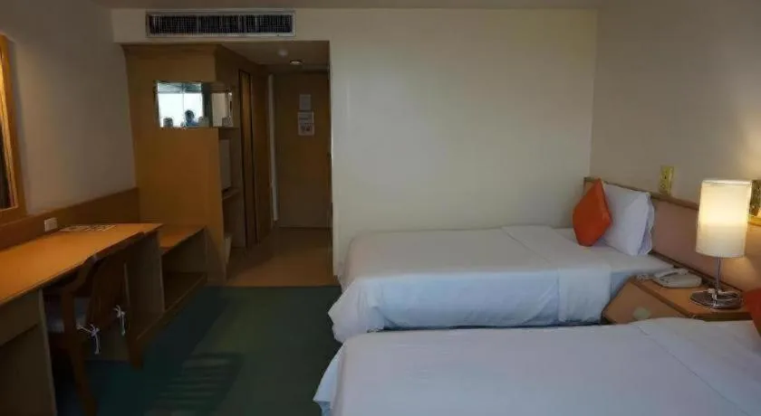 Bed in The Majestic Sakon Nakhon Hotel